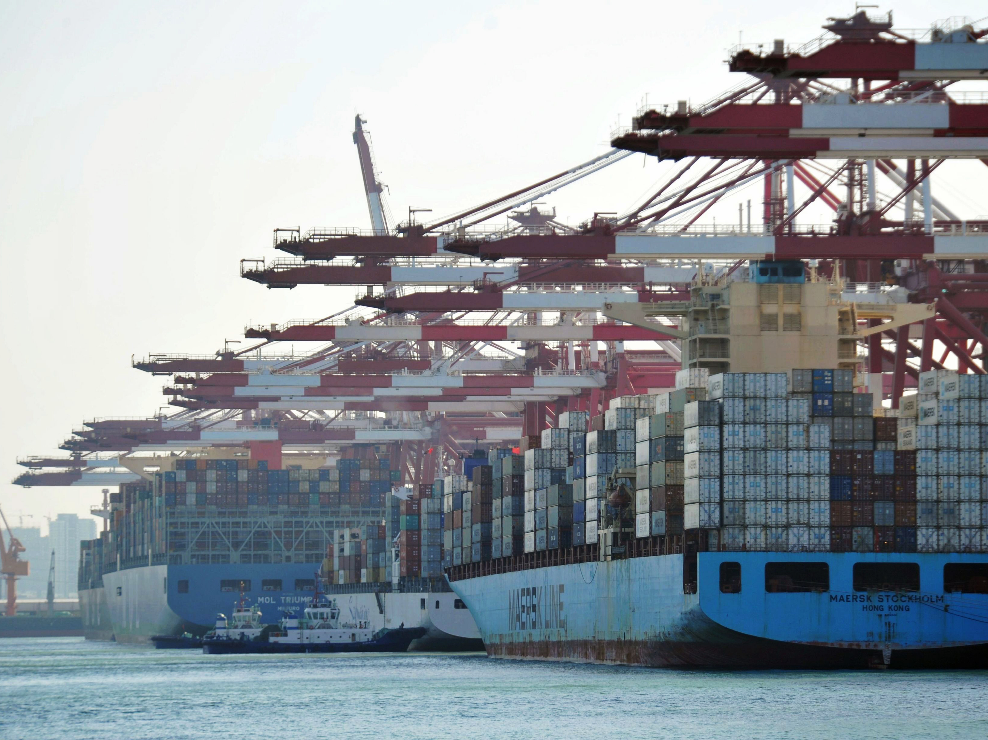 Cargo containers are loaded on ships at a port in Qingdao in China's eastern Shandong province in April. China said it will impose tariffs of 5 percent to 10 percent on $60 billion worth of U.S. products, starting on Monday. (AFP/Getty Images)