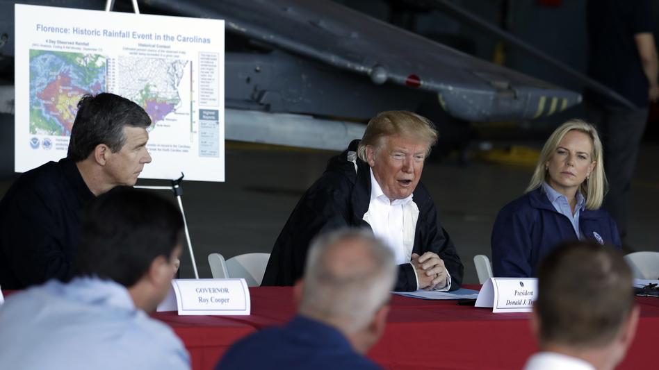 President Trump speaks while attending a briefing at Marine Corps Air Station Cherry Point in Havelock, N.C., on Wednesday, during a trip to visit areas impacted by Hurricane Florence. North Carolina Gov. Roy Cooper (left) and Homeland Security Secretary Kirstjen Nielsen (right) also attended the briefing. (Evan Vucci/AP)