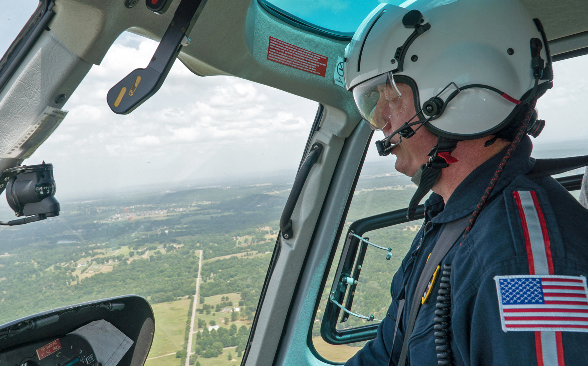 Chris Glascow, an Army veteran and pilot for Air Methods, flies over the border of Arkansas and Oklahoma. (Jackie Fortier/ StateImpact Oklahoma)