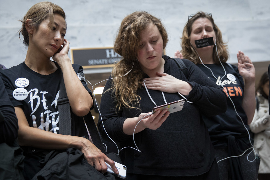 Protesters rallying against Kavanaugh watch testimony from Ford on a smartphone inside the Hart Senate Office Building in Washington, D.C. (Drew Angerer/Getty Images)