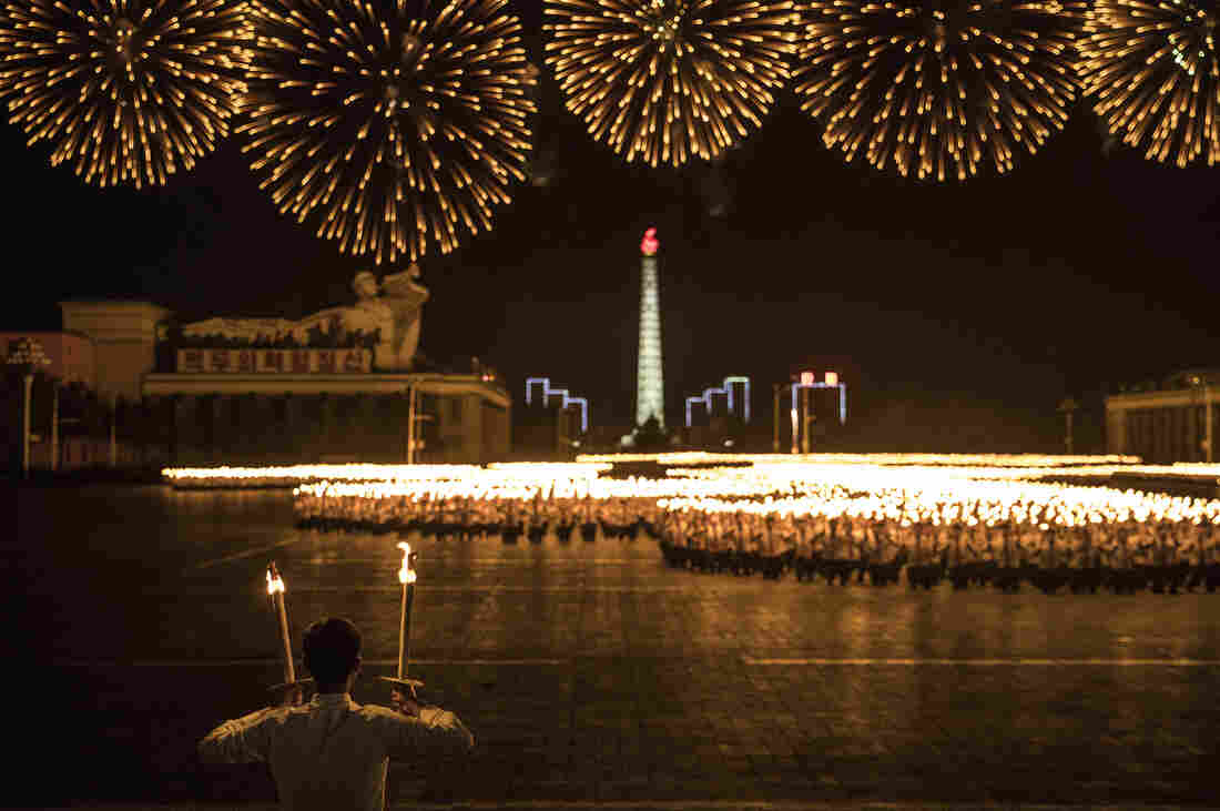 North Korean students hold a mass march carrying torches on Kim Il Sung Square in Pyongyang to mark its 70th anniversary of the nation's founding.