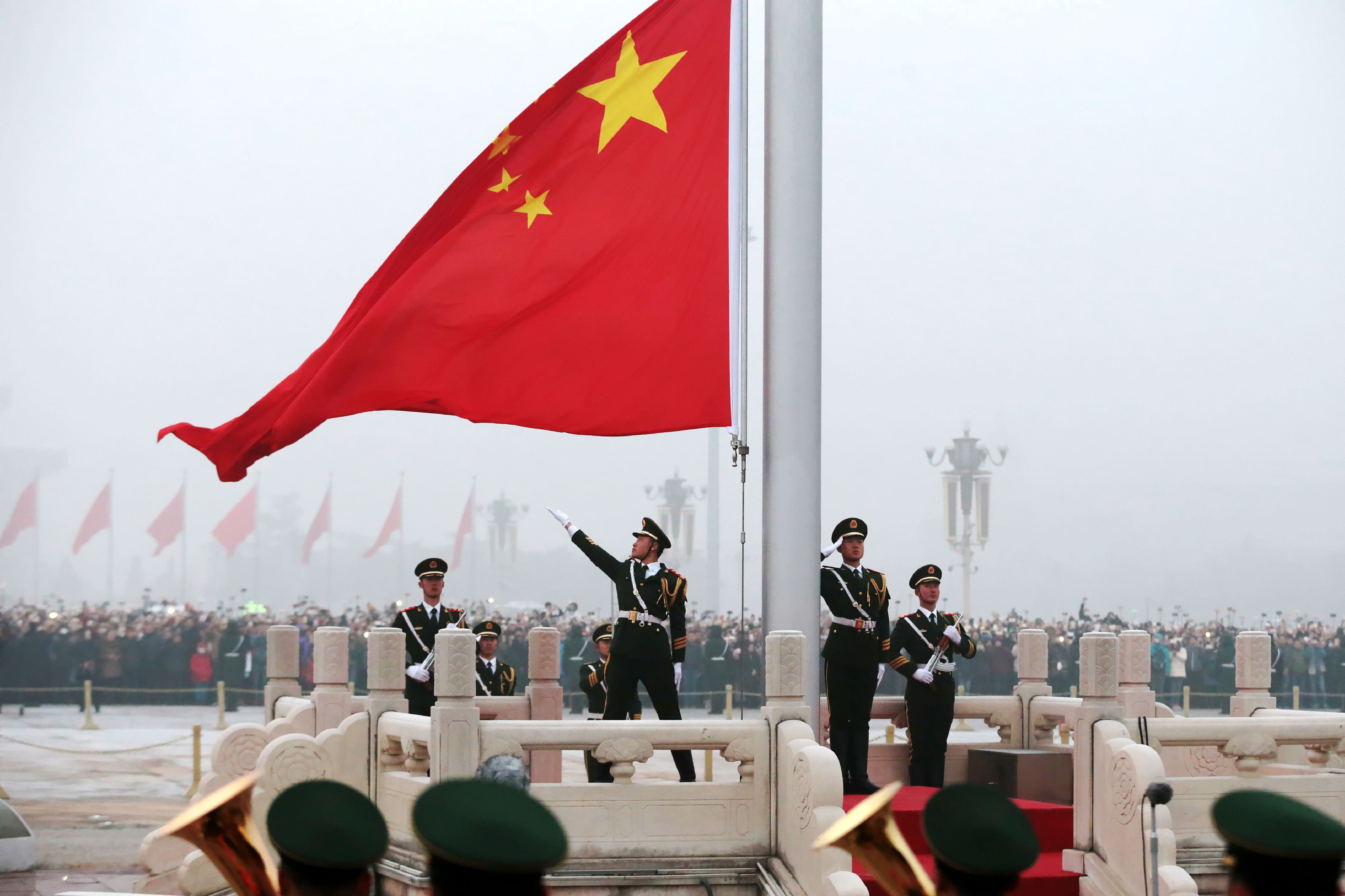Honor guards attend a flag-raising ceremony at Tiananmen Square in 2017. Under President Xi Jinping, China has ambitiously pressed its advantage almost everywhere at once. (VCG via Getty Images)