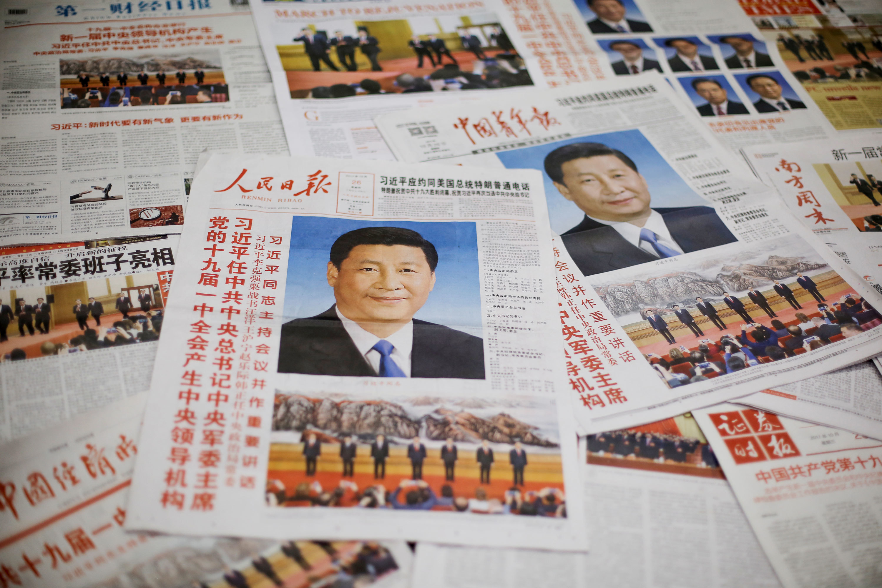 The front page of the Communist Party's flagship newspaper the <em>People's Daily</em> (center) and other papers are seen one day after the unveiling of the new Politburo Standing Committee in Beijing last year. (Reuters)