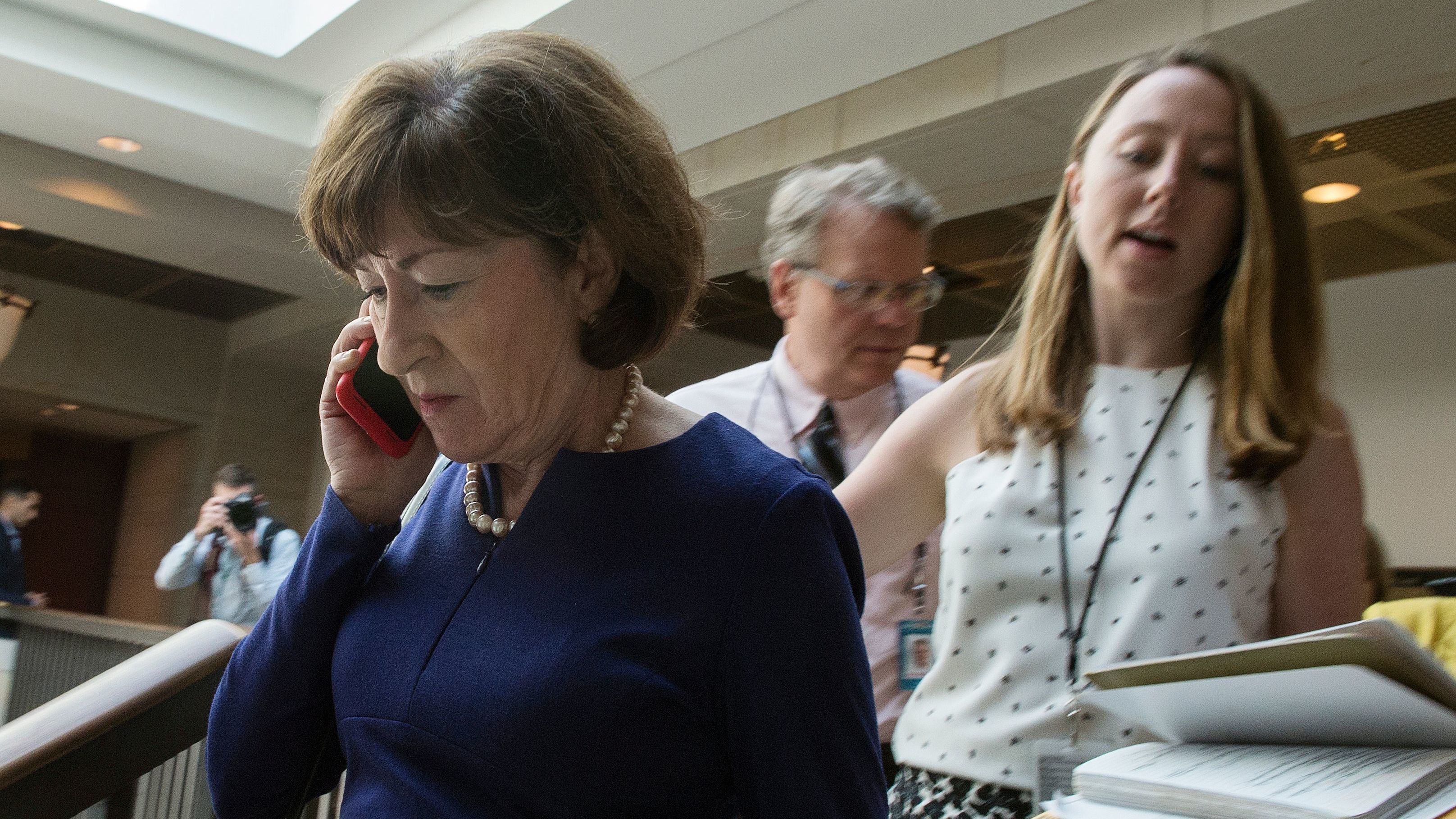 Sen. Susan Collins, R-Maine, talks on a phone while walking to a room on Capitol Hill to read the report on the supplemental FBI investigation into Supreme Court nominee Judge Brett Kavanaugh. (AFP/Getty Images)
