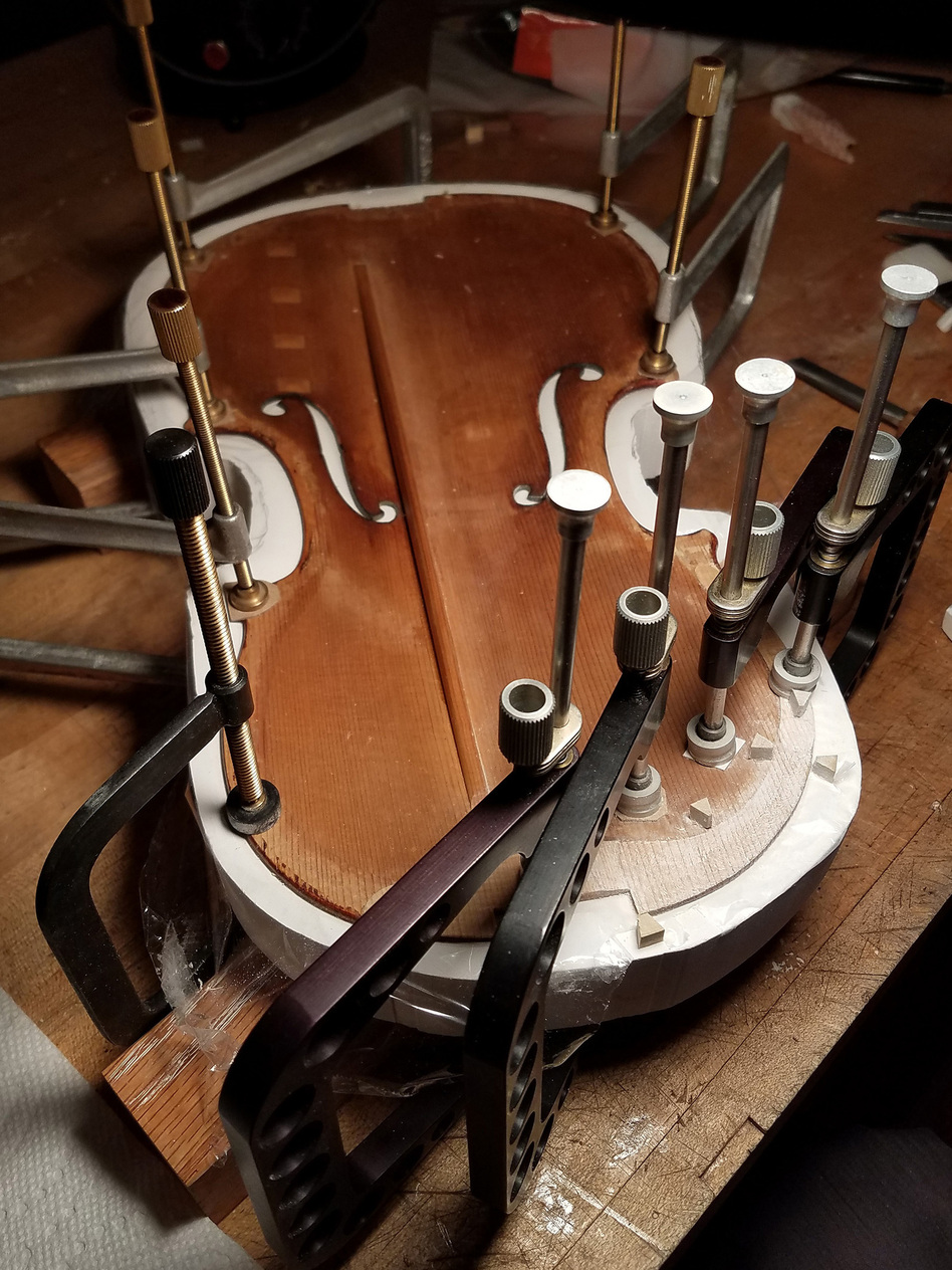 The Totenberg-Ames Stradivarius is pictured in a mold while being prepared to have its edge reinforced during restoration. (Courtesy of Bruno Price)