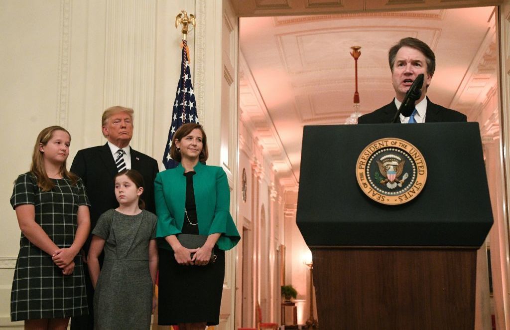 Newly sworn-in Supreme Court Justice Brett Kavanaugh speaks as his wife, daughters and President Trump listen on Monday. &quot;The Supreme Court is an institution of law. It is not a partisan or political institution,&quot; Kavanaugh said. (AFP/Getty Images)