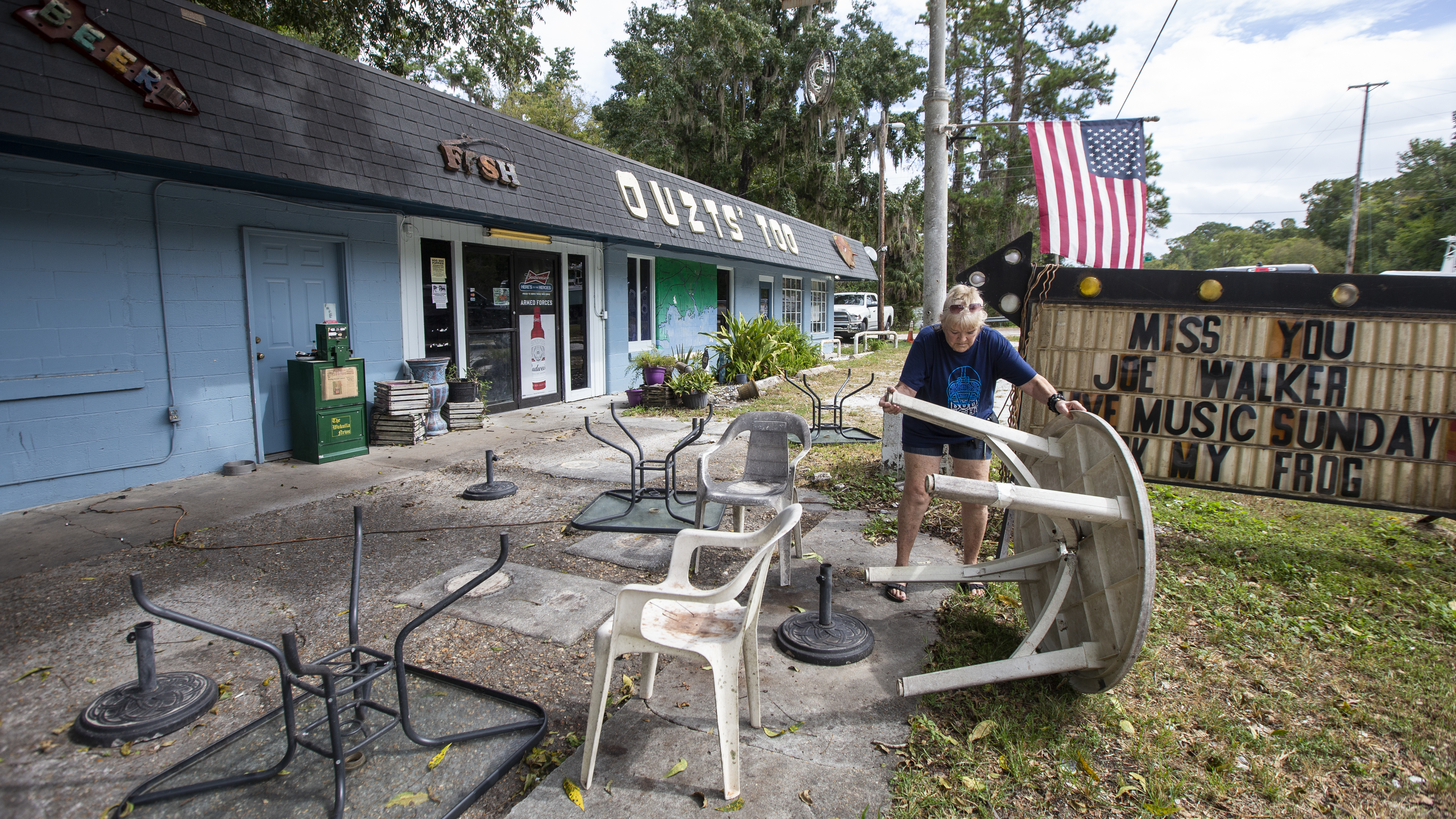 Bar owner Dorothy White puts away outdoor furniture at Ouzts Too bar prior to the arrival of Hurricane Michael on Tuesday near Newport, Fla. (Getty Images)