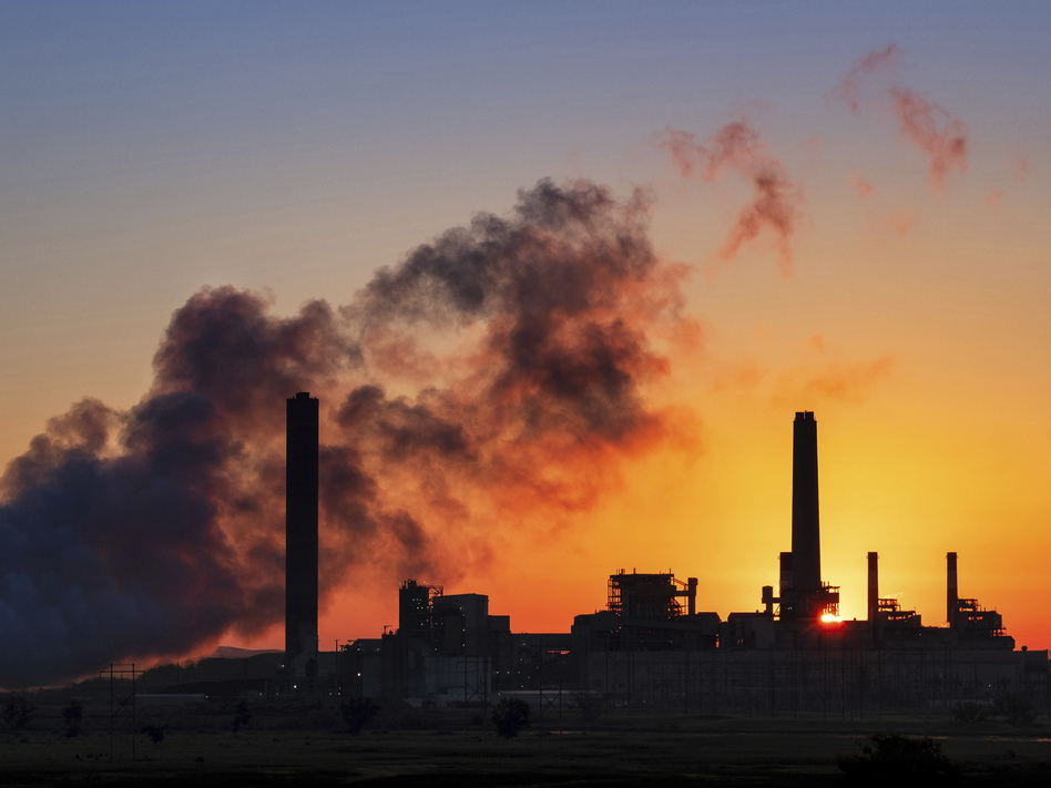 The Dave Johnson coal-fired power plant against the morning sun in Glenrock, Wyo. Democrats in some midterm swing races are targeting the Trump administration's environmental rollbacks and climate denial. (J. David Ake/AP)