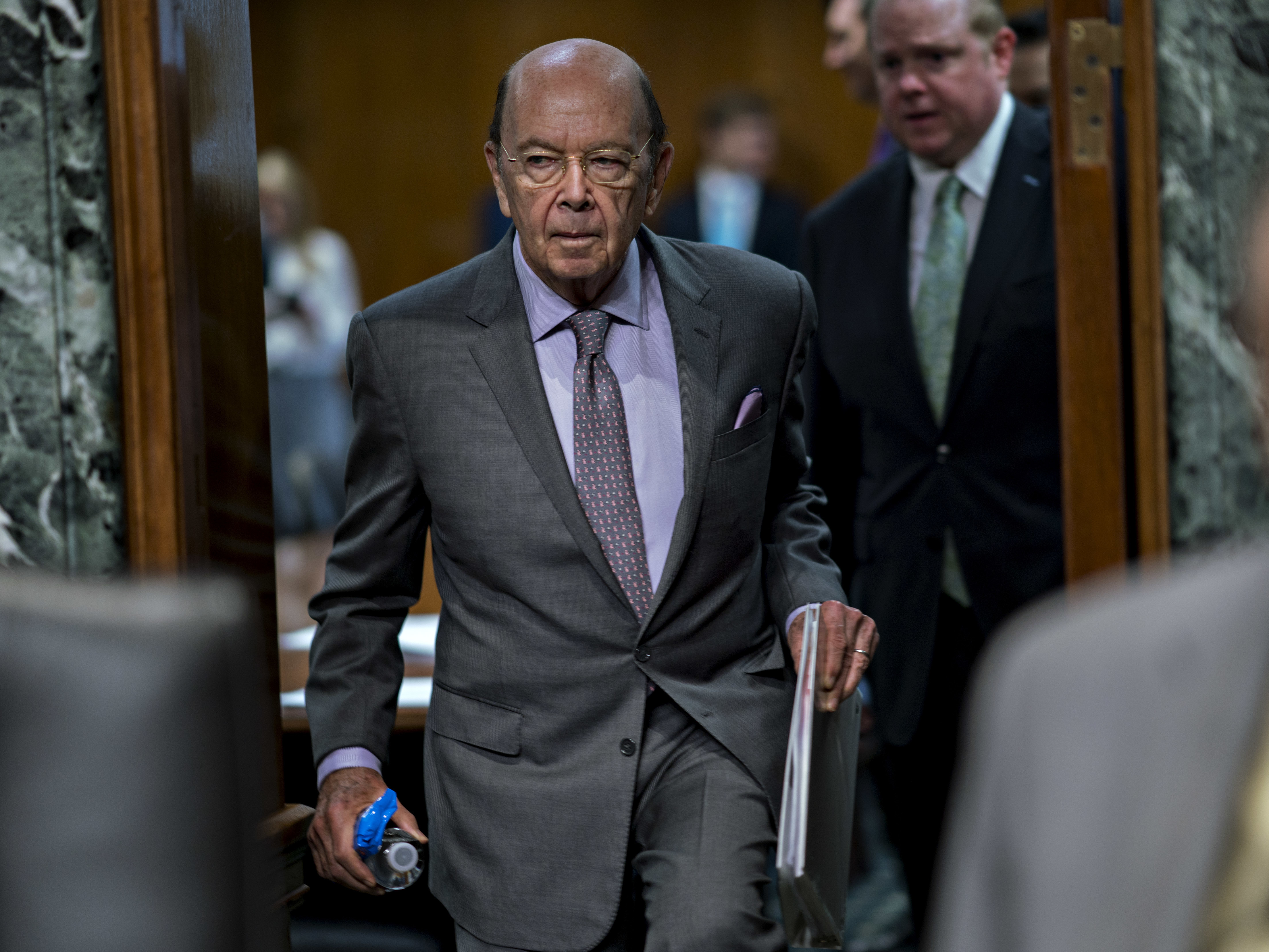 Commerce Secretary Wilbur Ross arrives at a U.S. Senate hearing in June. He added a citizenship question to the 2020 census that has sparked six lawsuits from dozens of states, cities and other groups that want it removed. (Bloomberg via Getty Images)