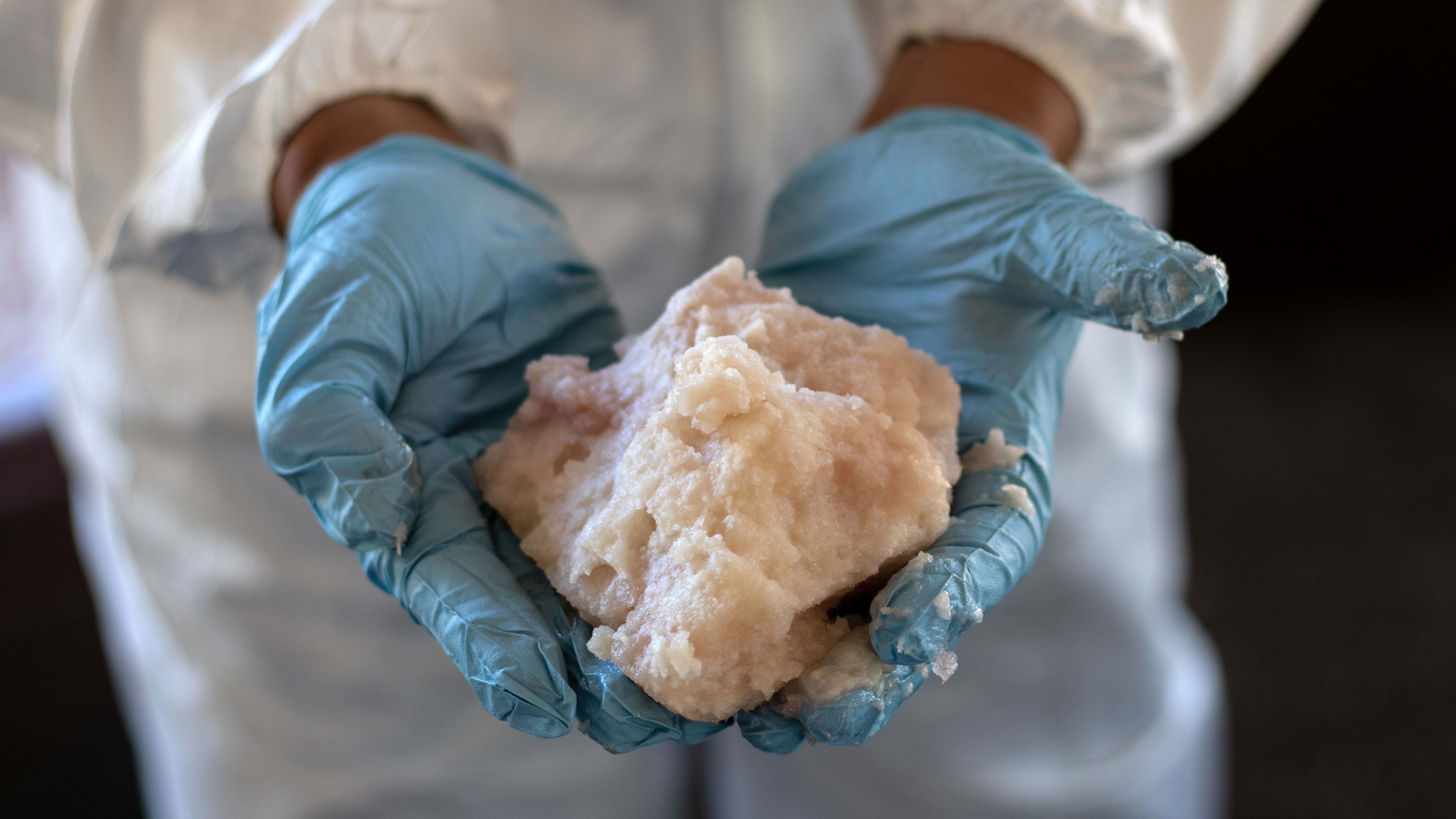 A drug specialist in the Mexican army shows crystal methamphetamine paste seized at a clandestine laboratory in Mexico