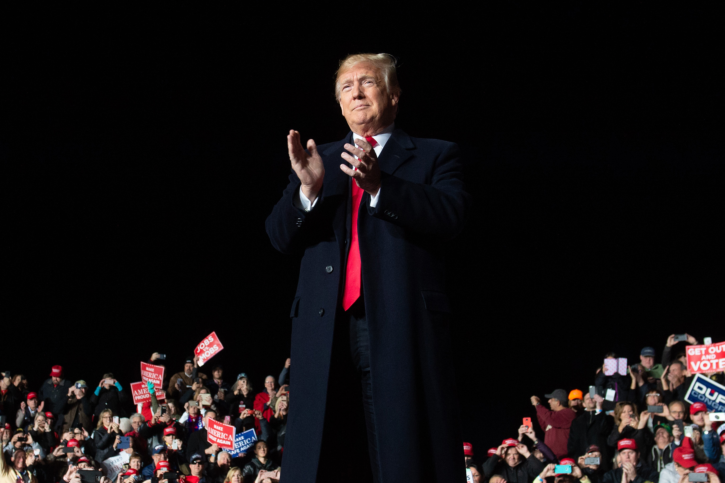 While President Trump called for unity at a campaign rally in Wisconsin on Wednesday, he has also criticized the news media. (AFP/Getty Images)