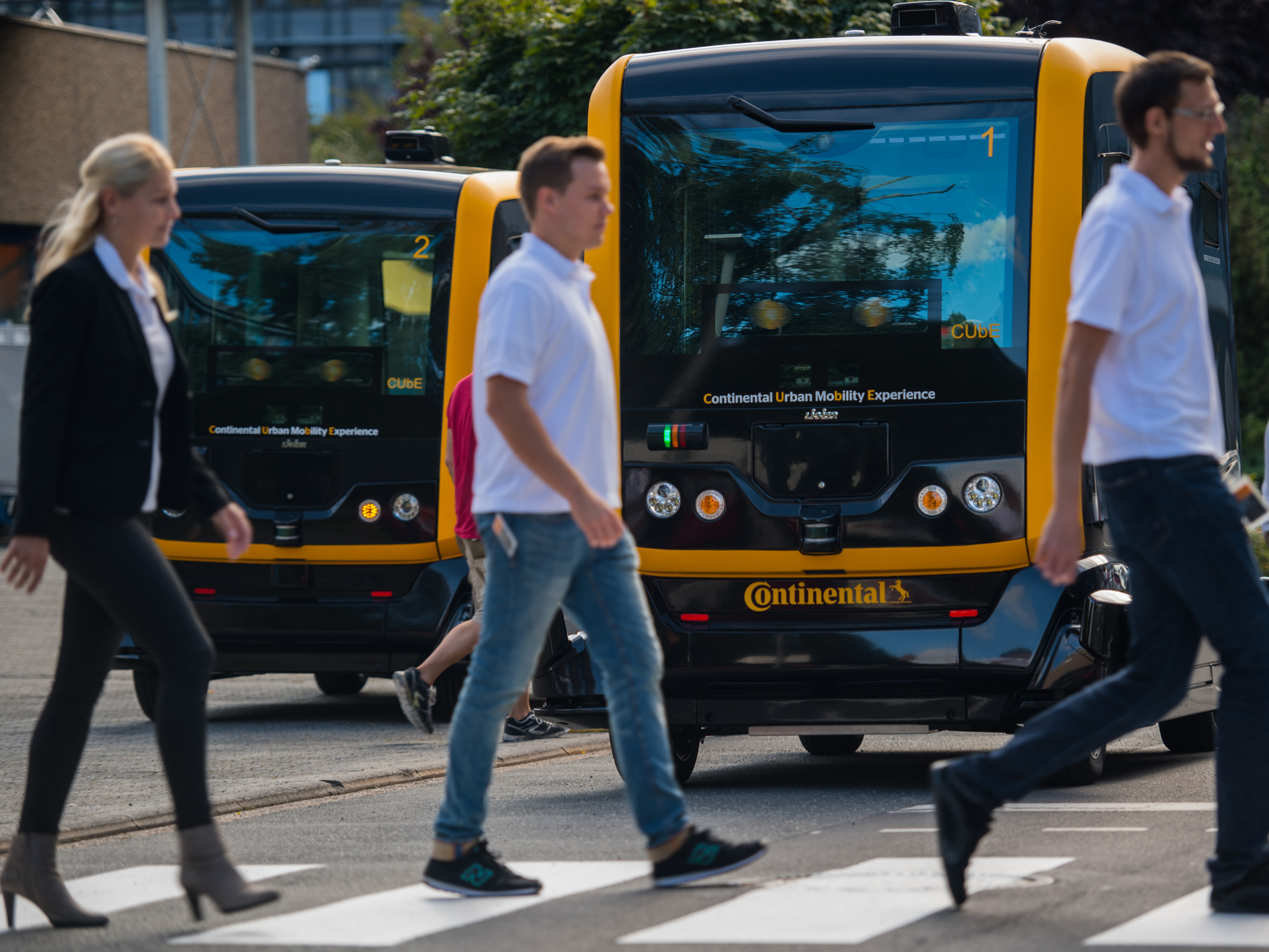 New research explores how people think autonomous vehicles should handle moral dilemmas. Here, people walk in front of an autonomous taxi being demonstrated in Frankfurt, Germany, last year. (Bloomberg via Getty Images)