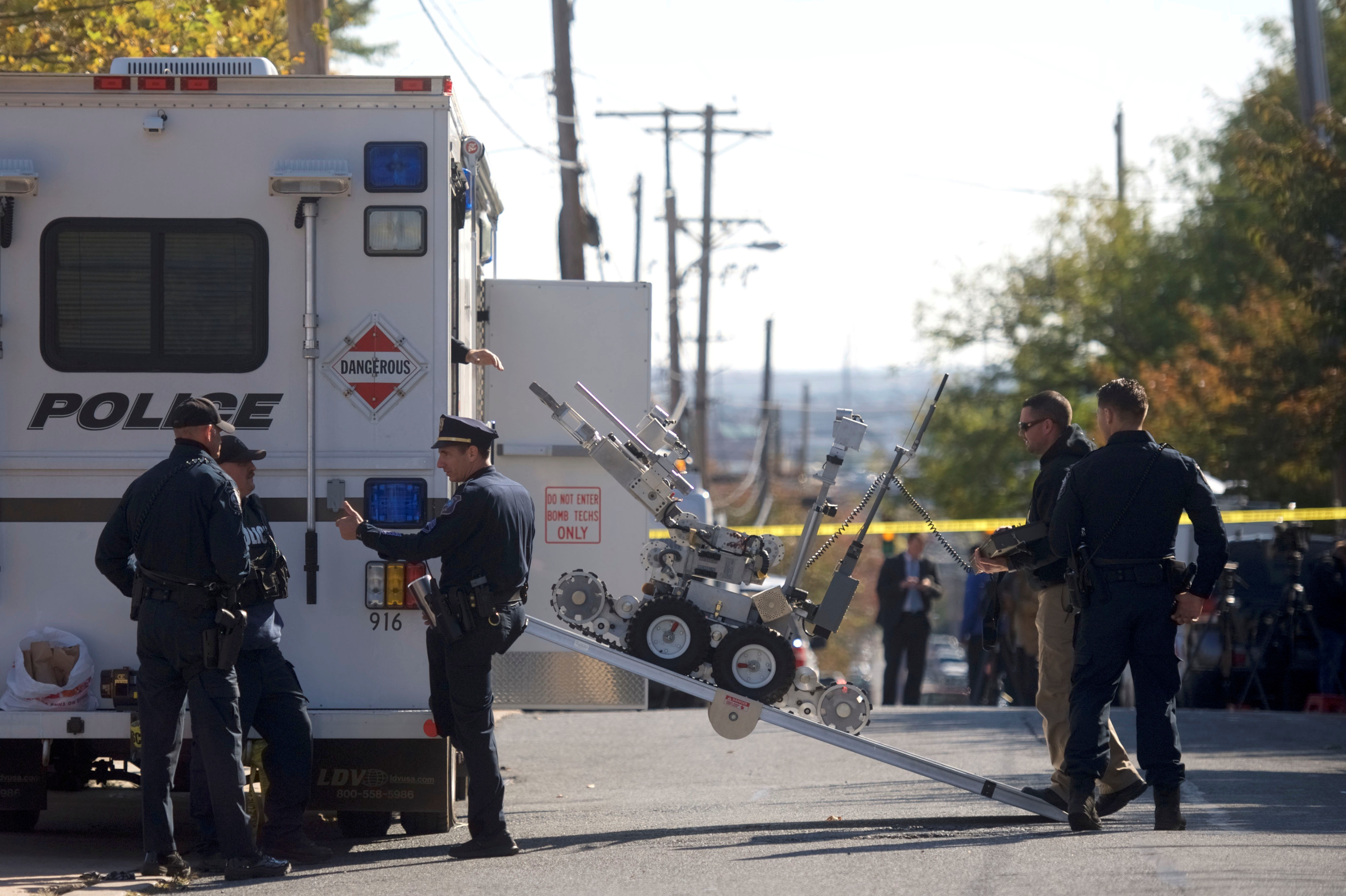Law enforcement personnel operate a bomb disposal robot outside a post office which had been evacuated in Wilmington, Del., on Thursday. (Reuters)