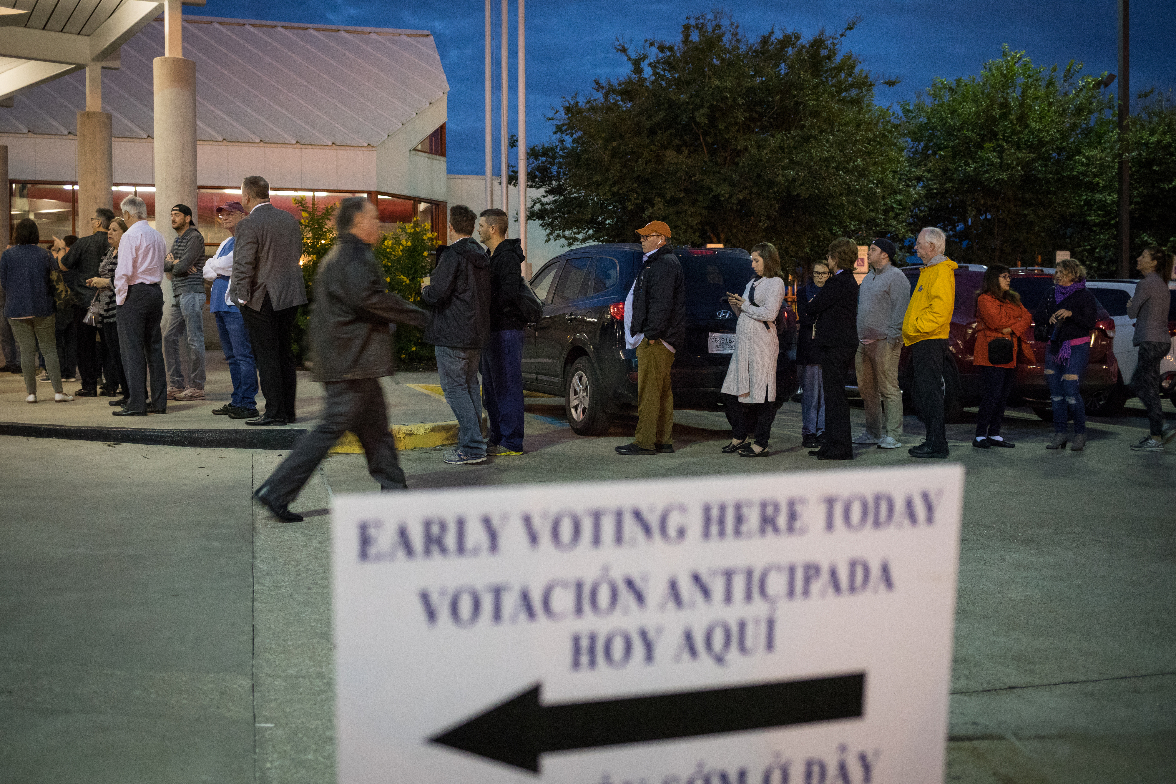 People wait in line to vote at a polling place on the first day of early voting on Oct. 22 in Houston. Texas Attorney General Ken Paxton has been aggressively prosecuting people for voting violations, which critics argue is designed to intimidate non-white voters. (Getty Images)