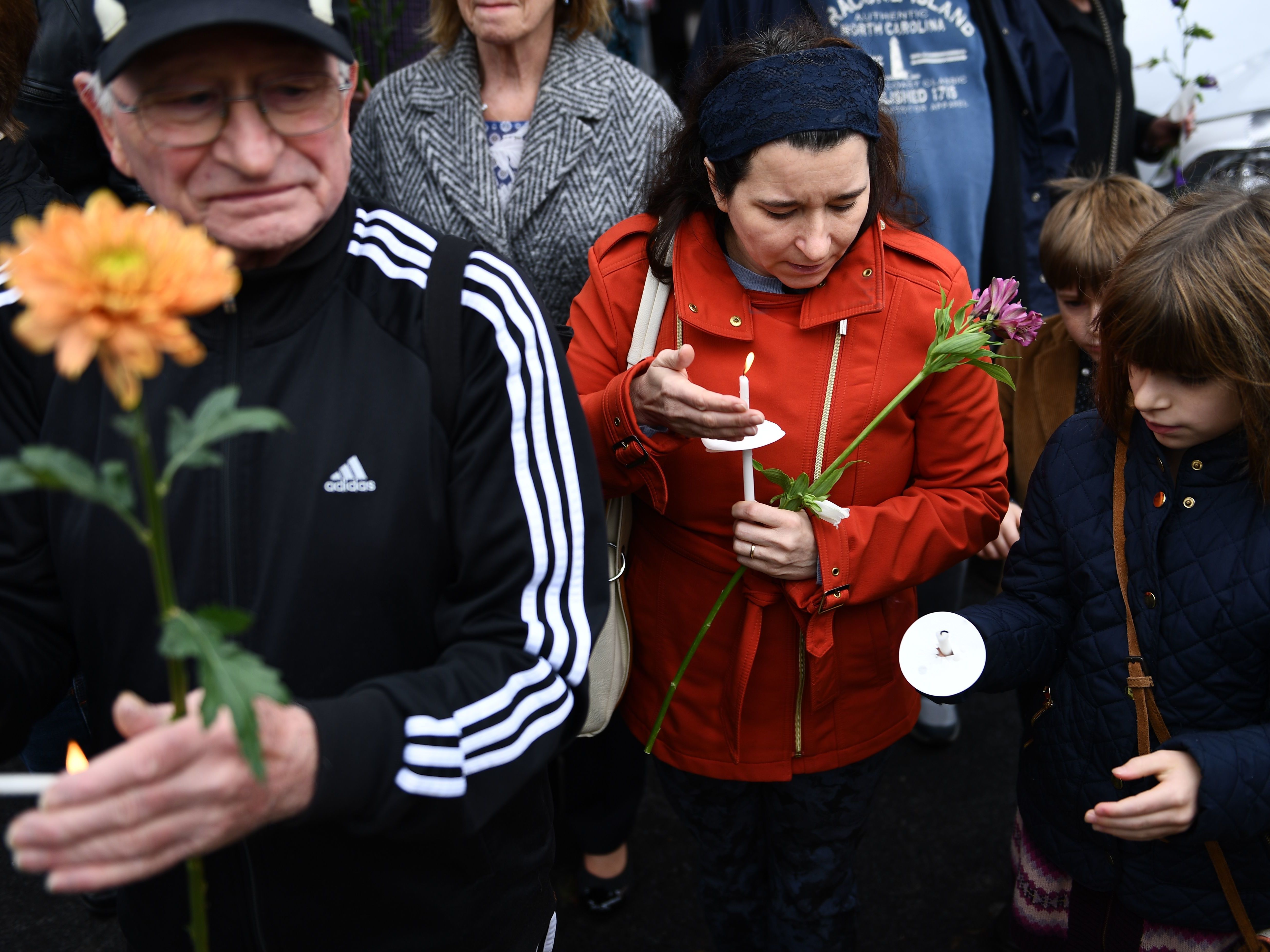 People pay their respects outside the Tree of Life synagogue in Pittsburgh. The 11 people who were killed on Saturday ranged in age from 54 to 97. (AFP/Getty Images)