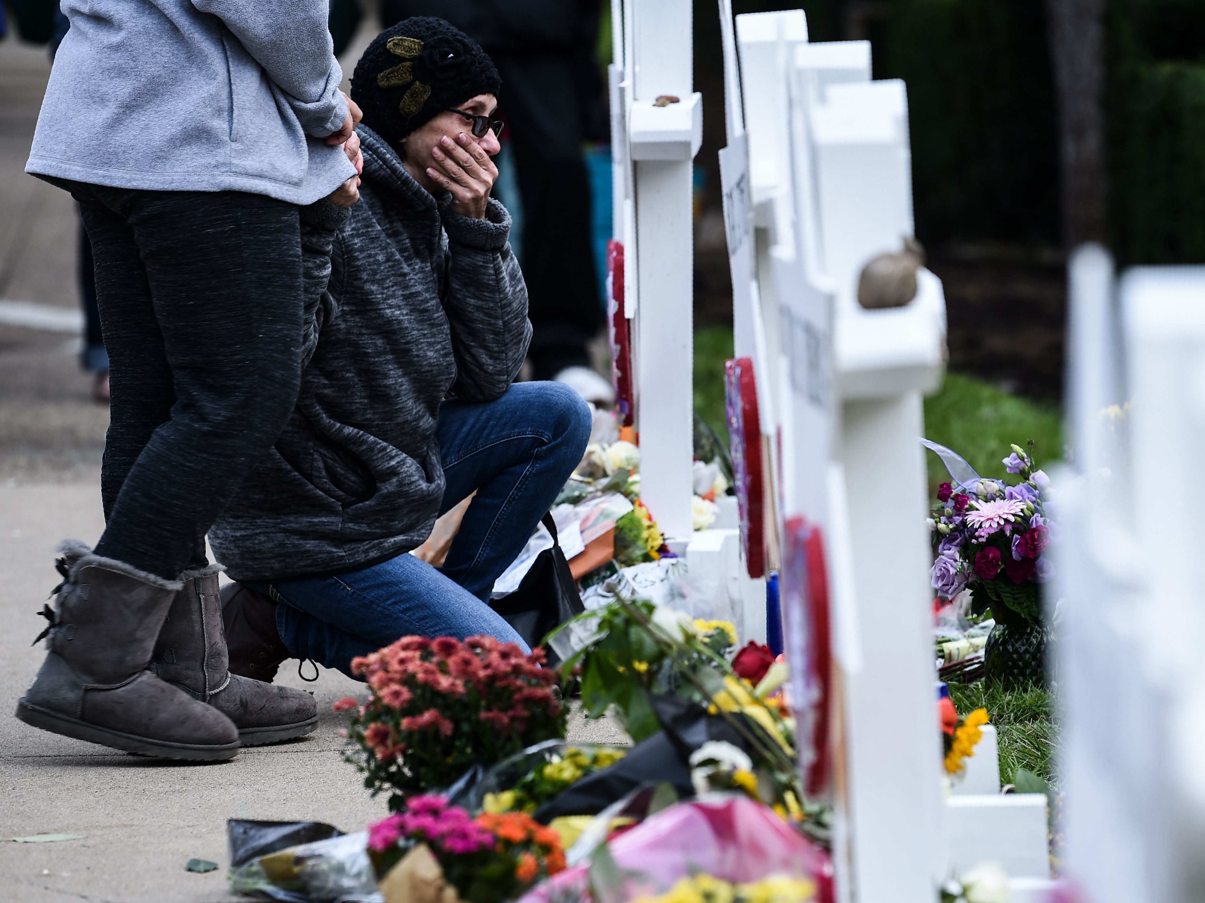 People pay their respects at a memorial outside the Tree of Life synagogue in Pittsburgh after a shooting there left 11 people dead. Many people see a connection between President Trump's anti-immigrant rhetoric and hate crimes. (AFP/Getty Images)