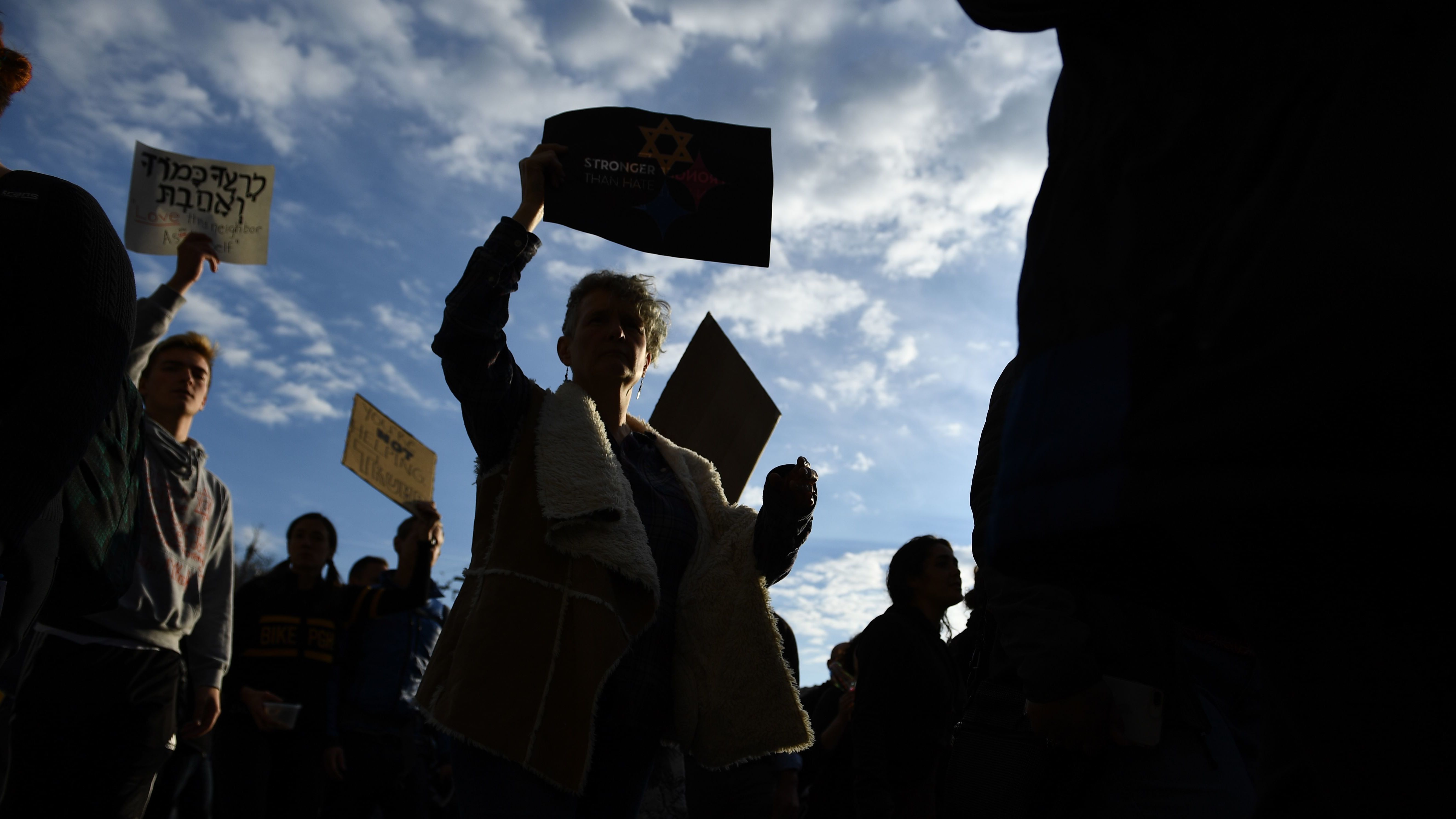 People protest the arrival of President Trump as he visits the Tree of Life synagogue in Pittsburgh on Tuesday. Many Americans fear more violence in U.S. political life. (AFP/Getty Images)