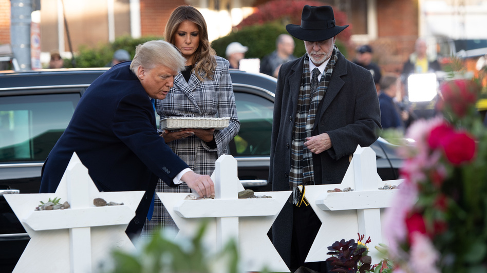 President Trump and first lady Melania Trump, alongside Rabbi Jeffrey Myers, place stones on a memorial as they pay their respects at the Tree of Life Synagogue in Pittsburgh on Tuesday. (Saul Loeb/AFP/Getty Images)