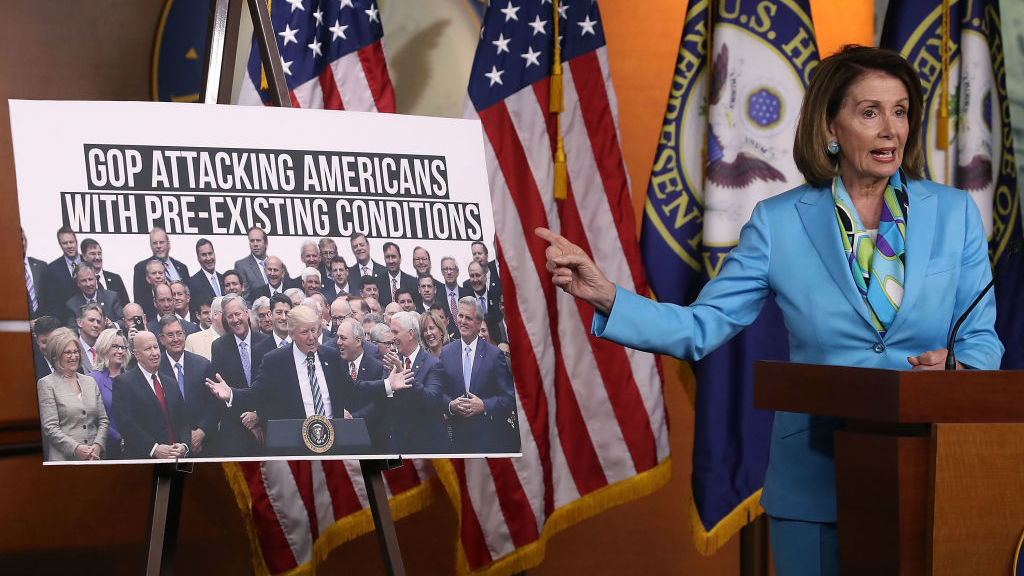 Democratic Minority Leader Nancy Pelosi, D-Calif., speaks about health care as she points to a picture of President Trump with House GOP members during her weekly news conference on Capitol Hill in June. (Getty Images)