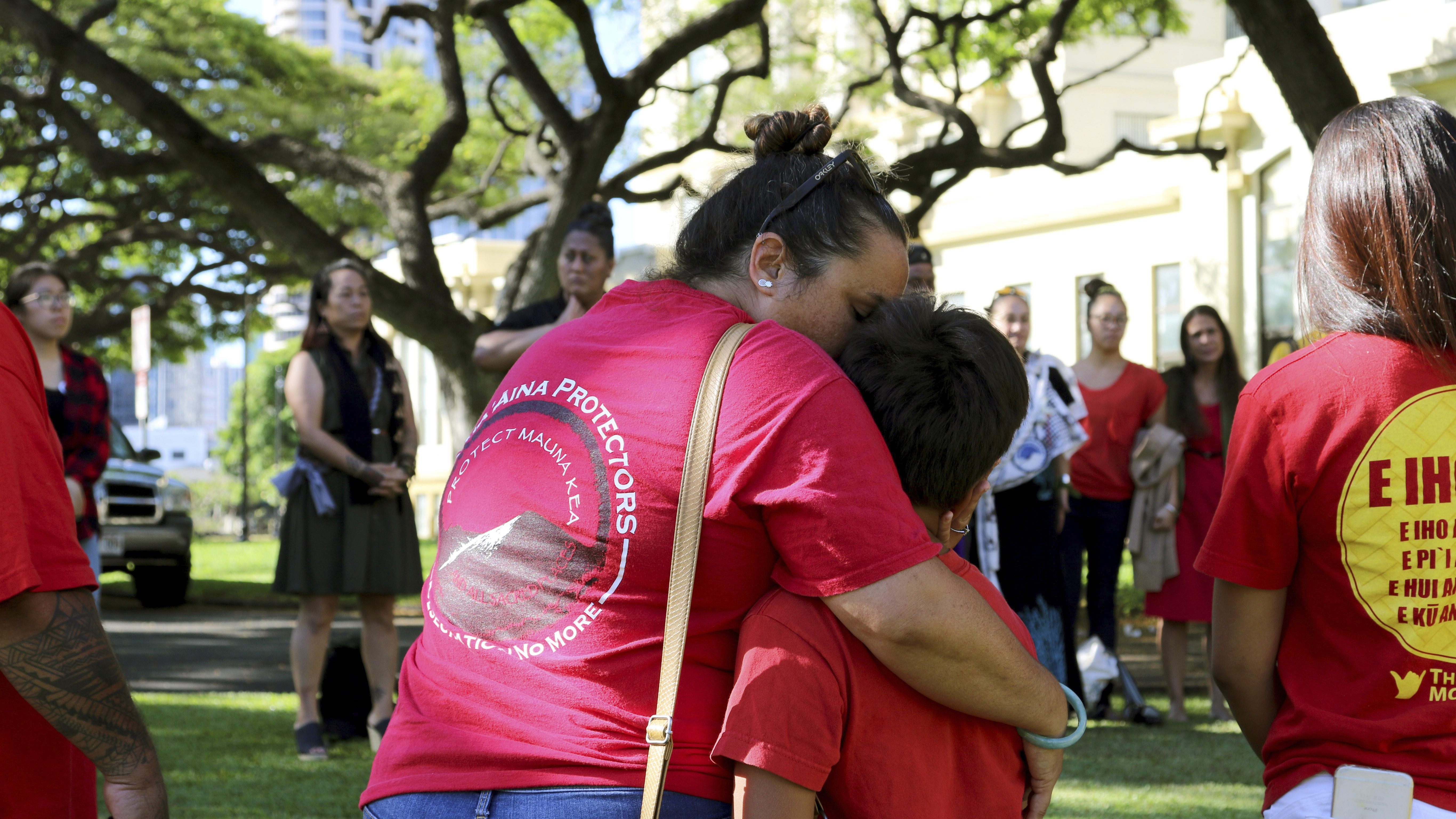 Joanna Pokipala and her son Kala Pokipala embrace while gathered with telescope protesters outside the Hawaii Supreme Court building in Honolulu in June.