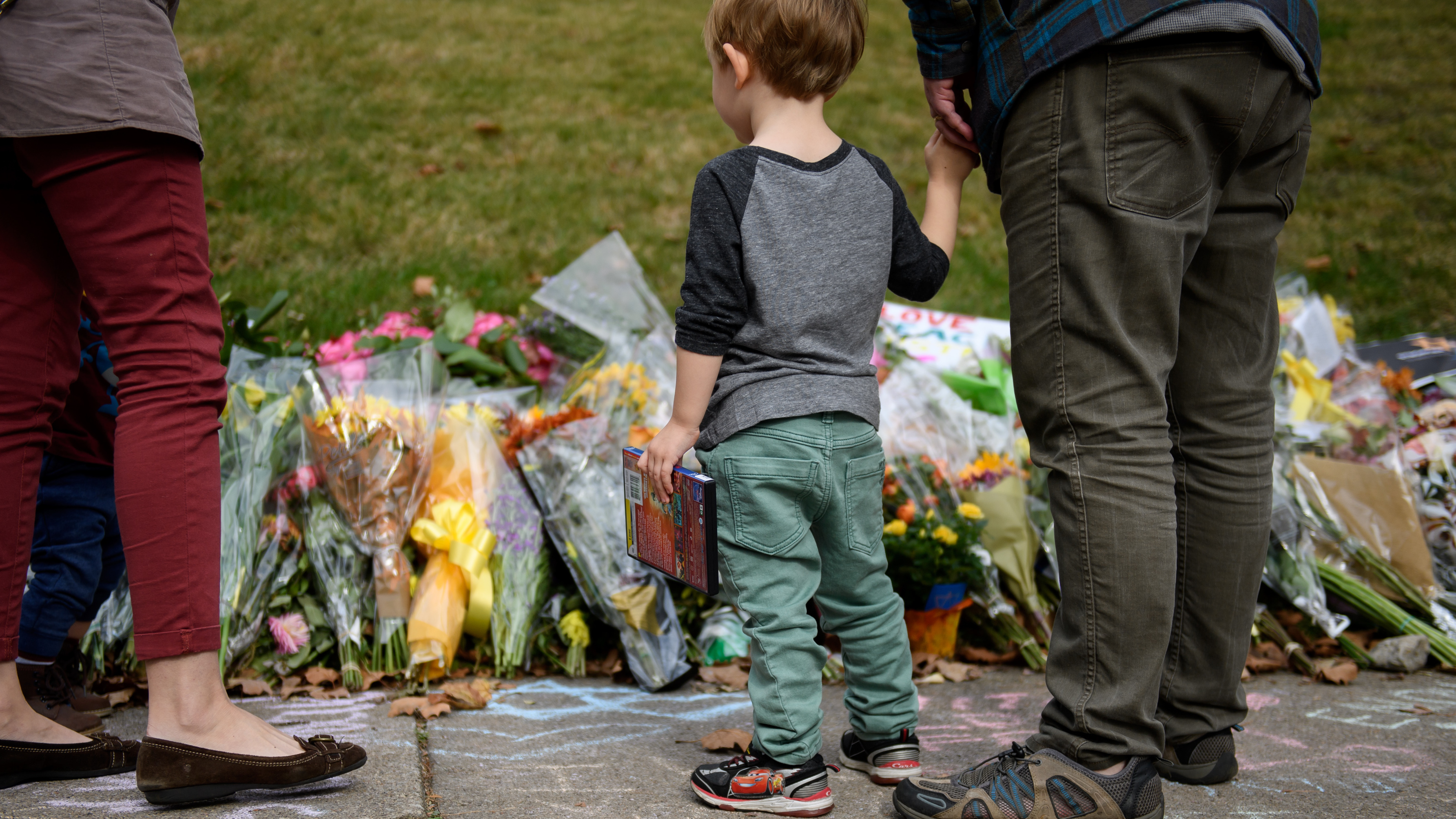 Mourners visit the memorial outside the Tree of Life Synagogue in Pittsburgh after eleven people were killed in a mass shooting last weekend. Security remains tightened as congregations prepare to celebrate Shabbat. (Getty Images)