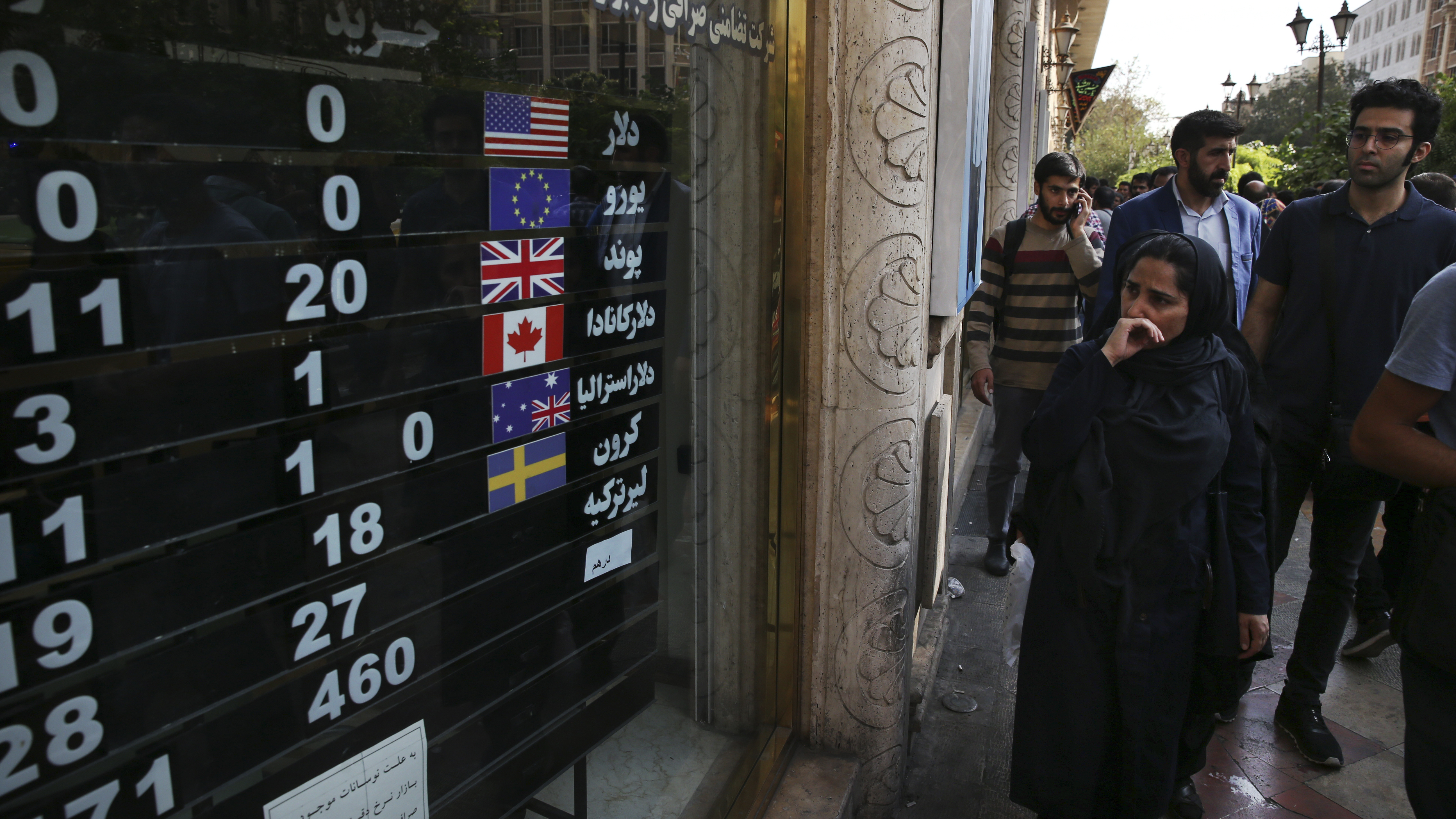An exchange shop displays rates for various currencies in downtown Tehran last month. Iran is bracing for the restoration of U.S. sanctions on its vital oil industry set to take effect on Monday, as it grapples with an economic crisis that has sparked sporadic protests over rising prices, corruption and unemployment.
