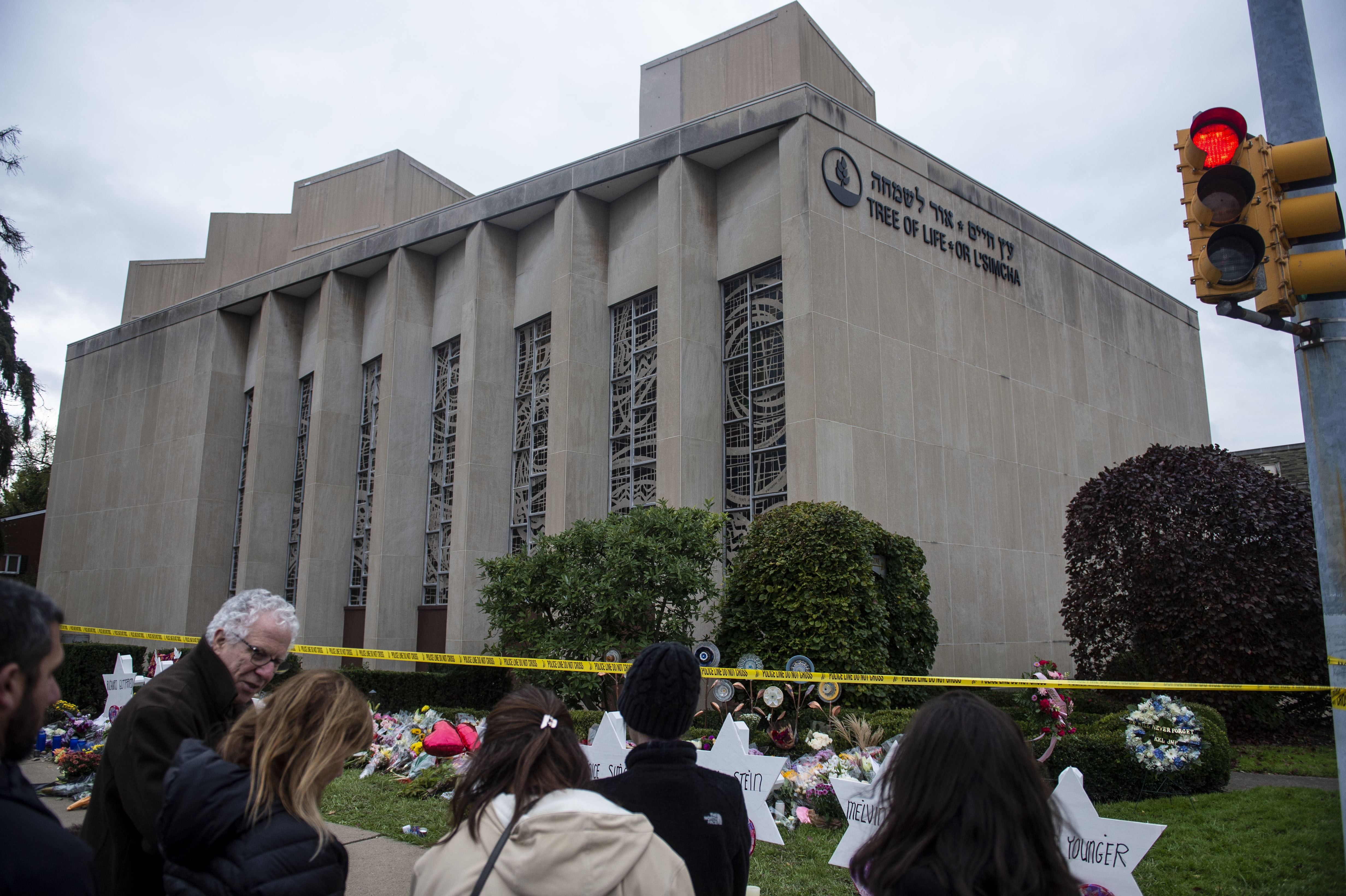 Members of Pittsburgh and the Squirrel Hill community pay their respects at the memorial to the 11 victims of the Tree of Life Synagogue massacre last Saturday. (SOPA Images/LightRocket via Getty Images)