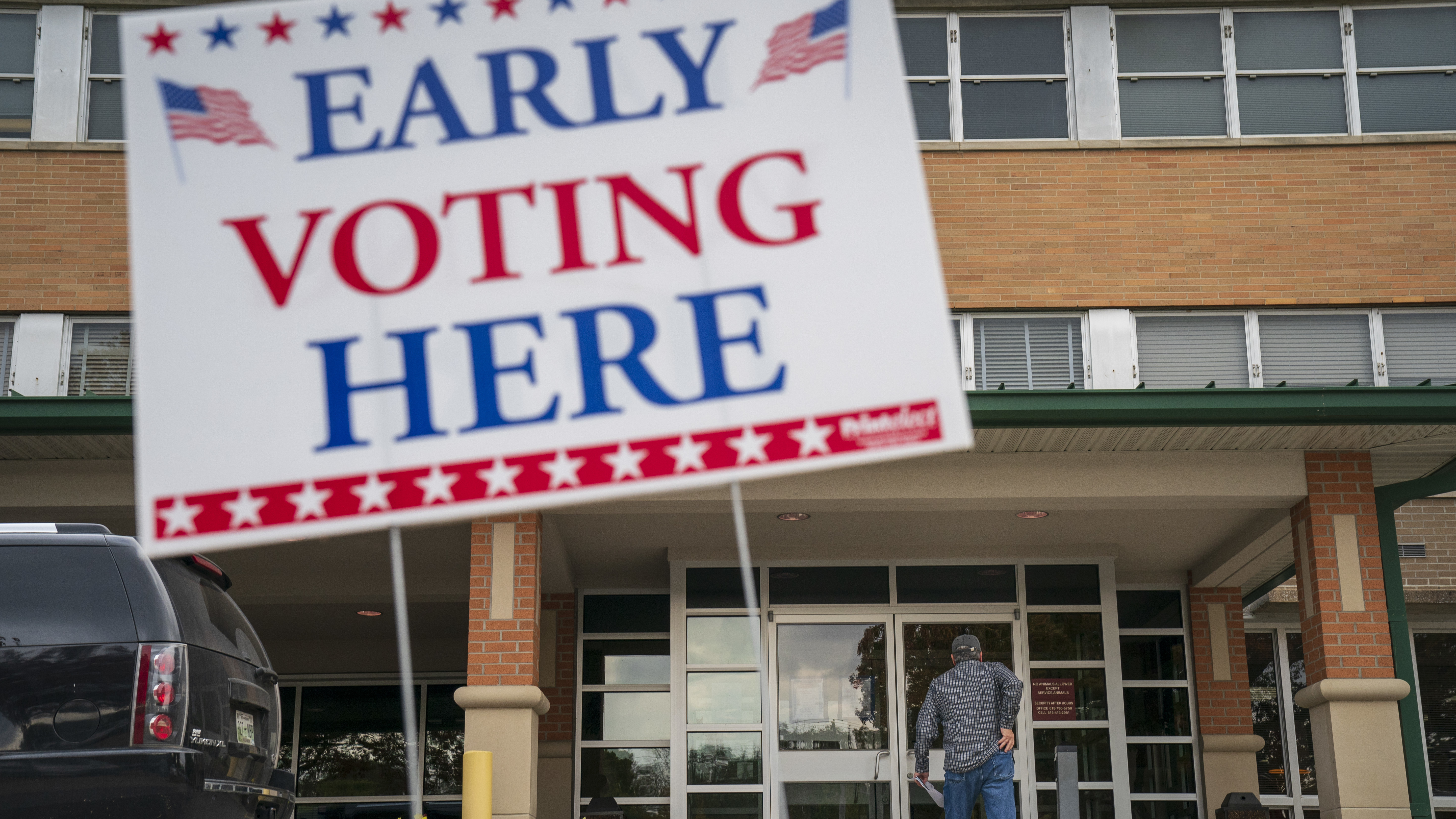 A man arrives at an early voting polling place at the Williamson County Clerk