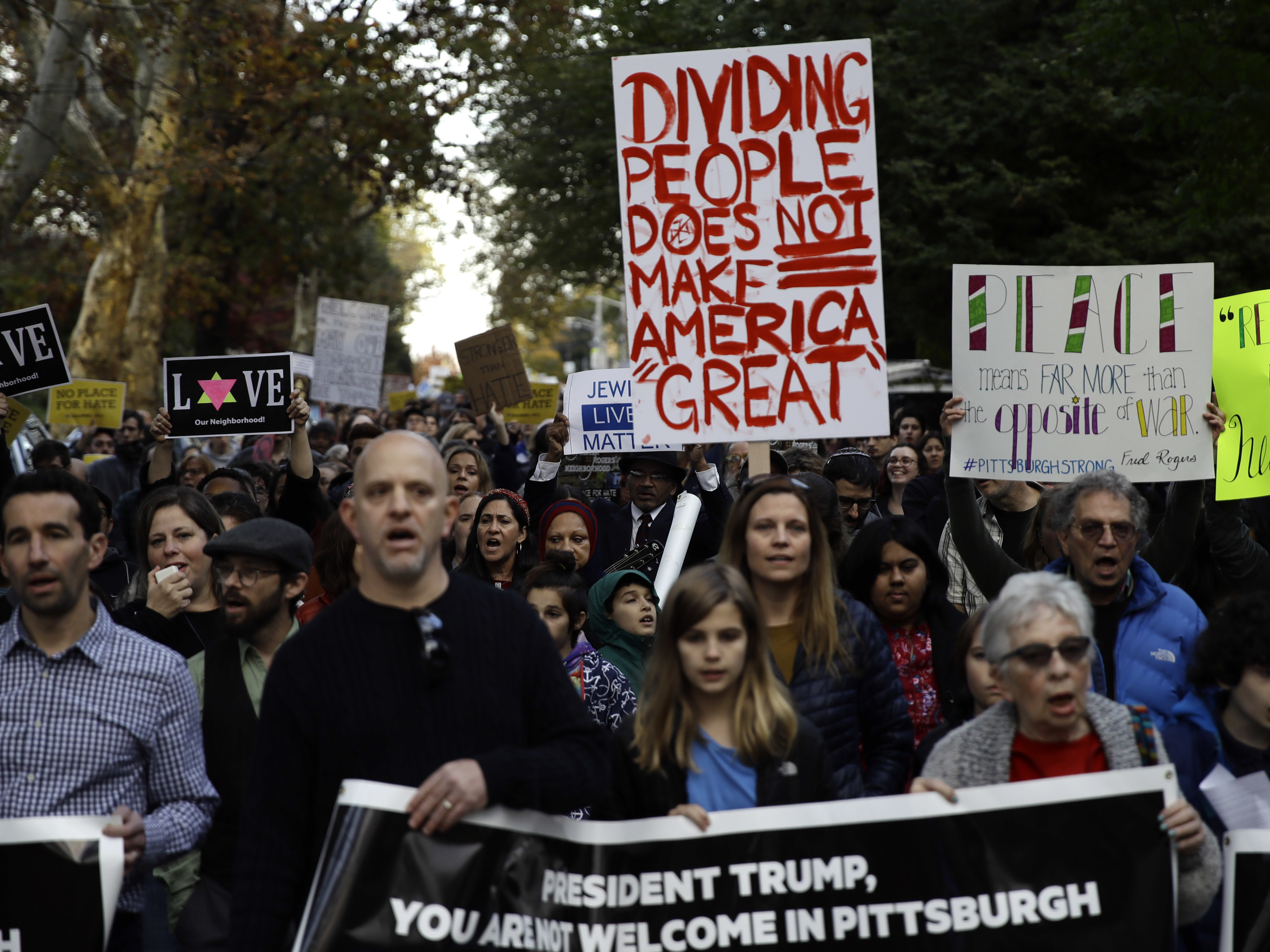 Protesters demonstrate near Pittsburgh's Tree of Life Synagogue where President Trump paid respects on Tuesday. The shooting there and heated reactions to it added to the anxiety leading up to the midterm vote.
