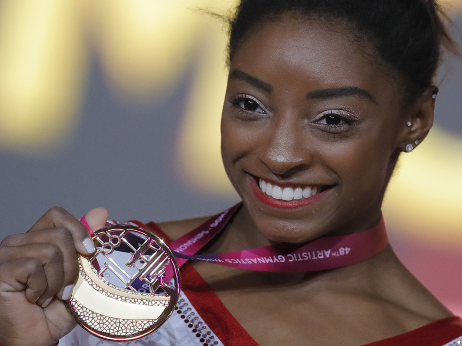 Simone Biles of the U.S. shows her gold medal after the women's vault final at the gymnastics World Championships in Doha, Qatar, last week.