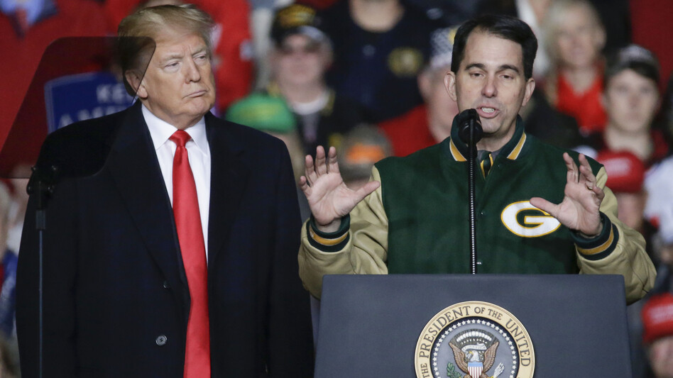 With President Trump at his side, Wisconsin Gov. Scott Walker speaks during a rally in Mosinee, Wis., on Oct. 24. (Mike Roemer/AP)