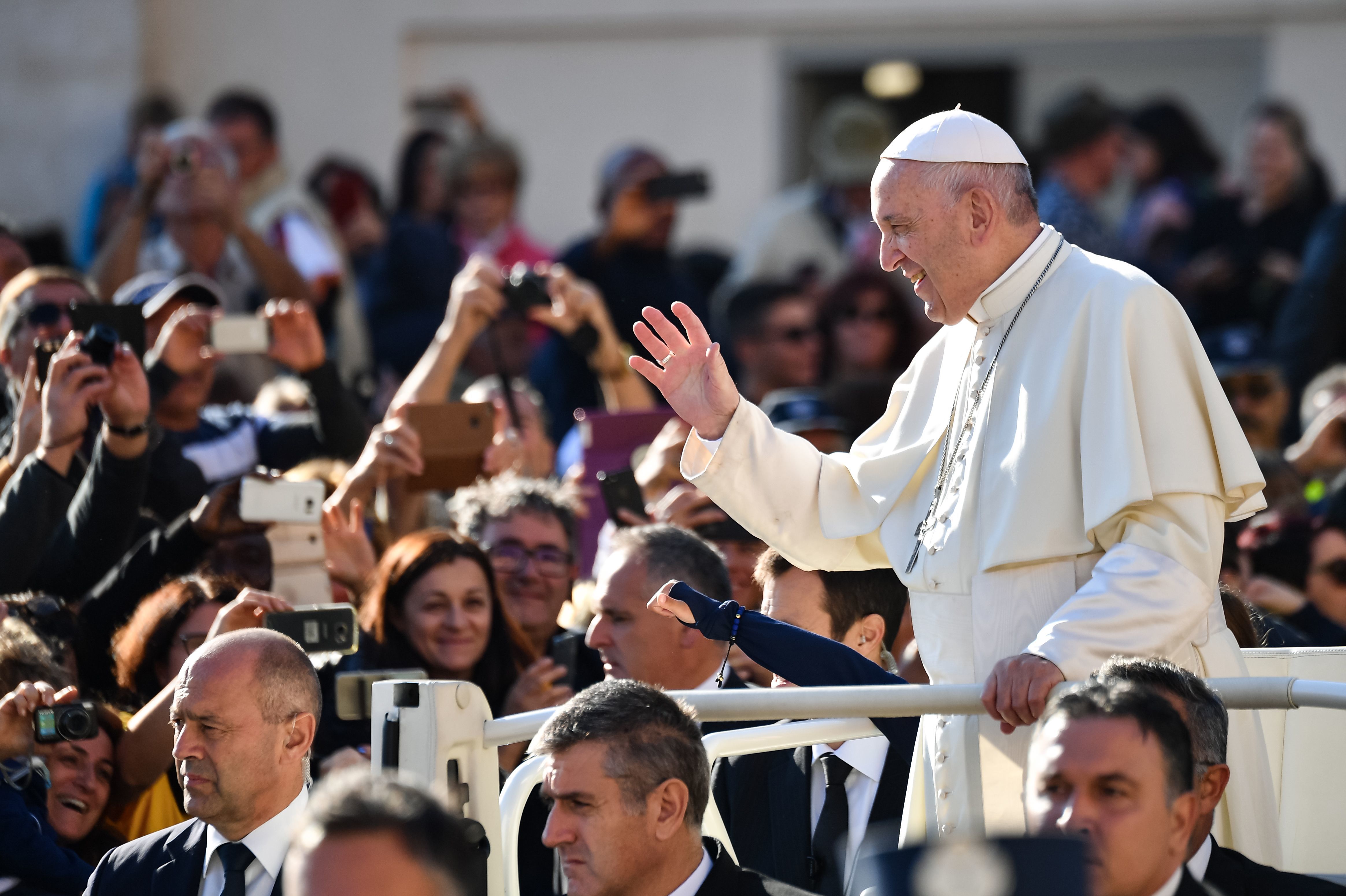 Pope Francis greets the crowd in the Vatican's St. Peter's Square in October. Many of the pope's most vocal opponents are in the United States, attacking him in tweets, blogs and politically conservative media. (AFP/Getty Images)