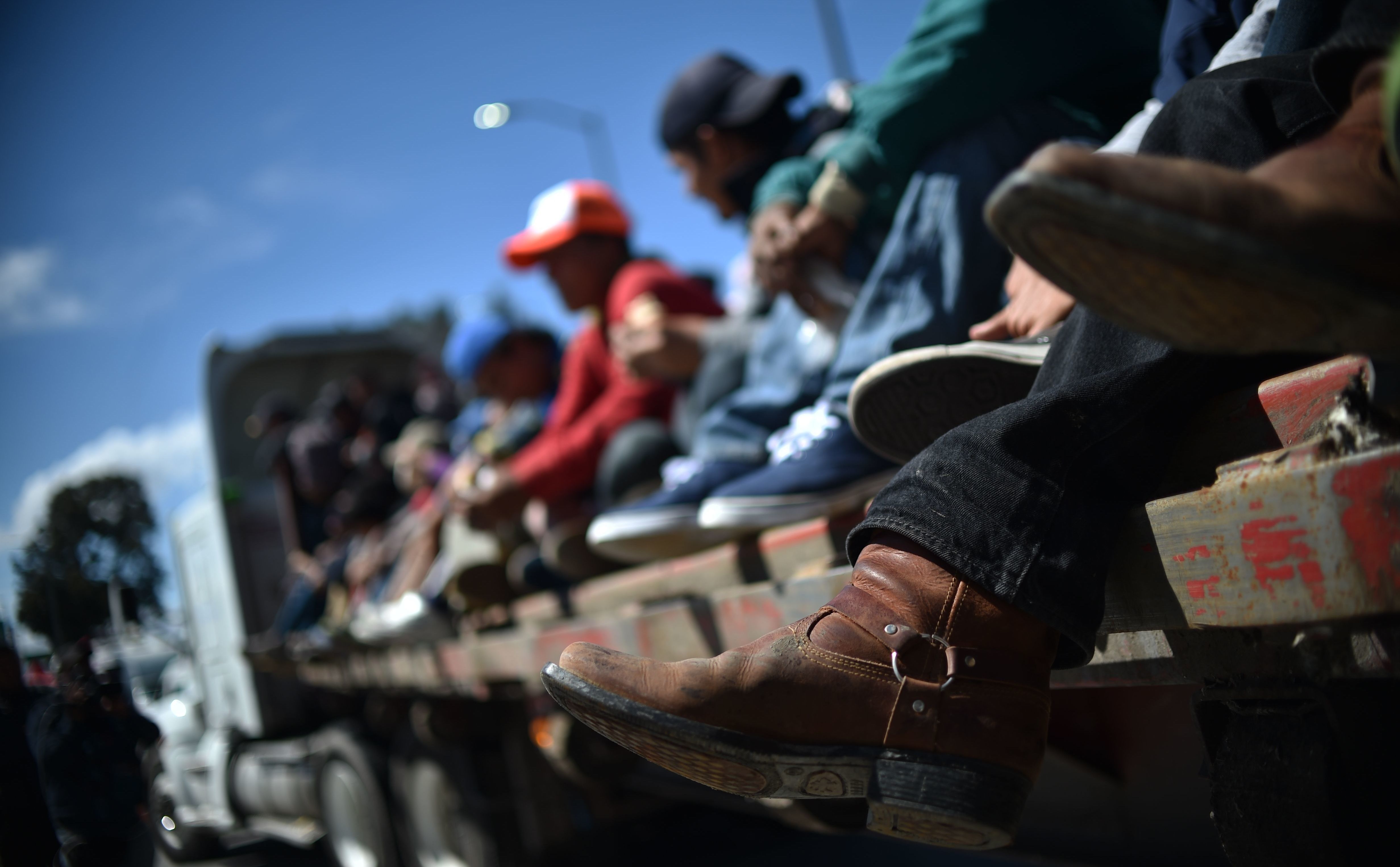 Migrants from Central America ride in a truck Monday as they travel toward the U.S. on the Mexico City-Puebla highway. Thursday, the Trump administration issued new a new rule for asylum-seekers. (AFP/Getty Images)