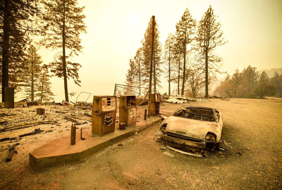 As the Camp Fire burns nearby, a scorched car rests by gas pumps on Sunday near Pulga, Calif., a community located in Northern California's Butte County. (Josh Edelson/AFP/Getty Images)