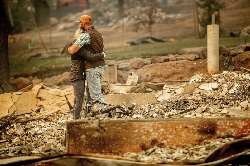 Chris and Nancy Brown embrace while searching through the remains of their home, leveled by the Camp Fire in Paradise, Calif. (Noah Berger/AP)