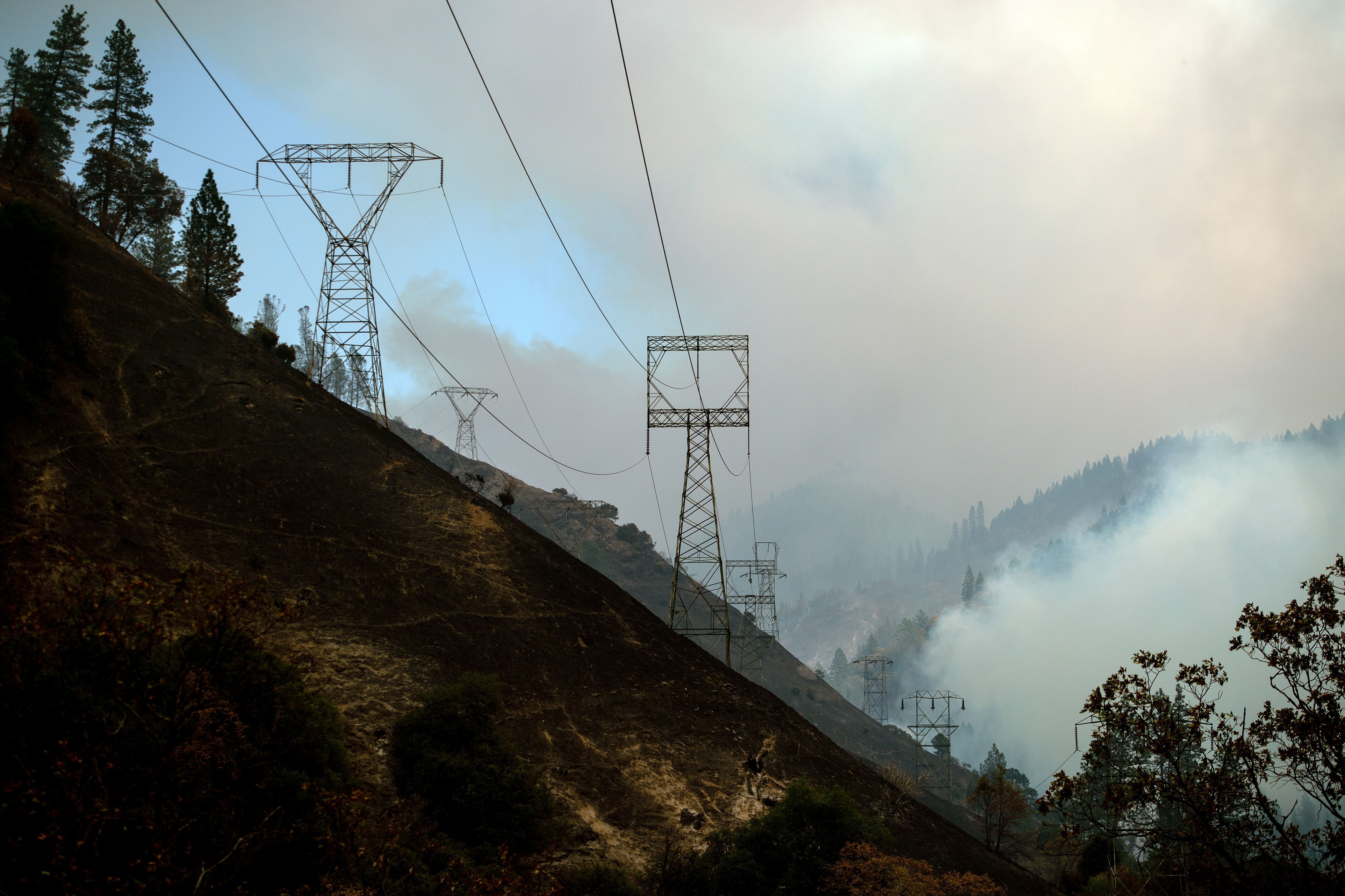 Power lines are seen through smoke from the Camp Fire near Pulga, Calif., on Sunday. (Josh Edelson/AFP/Getty Images)