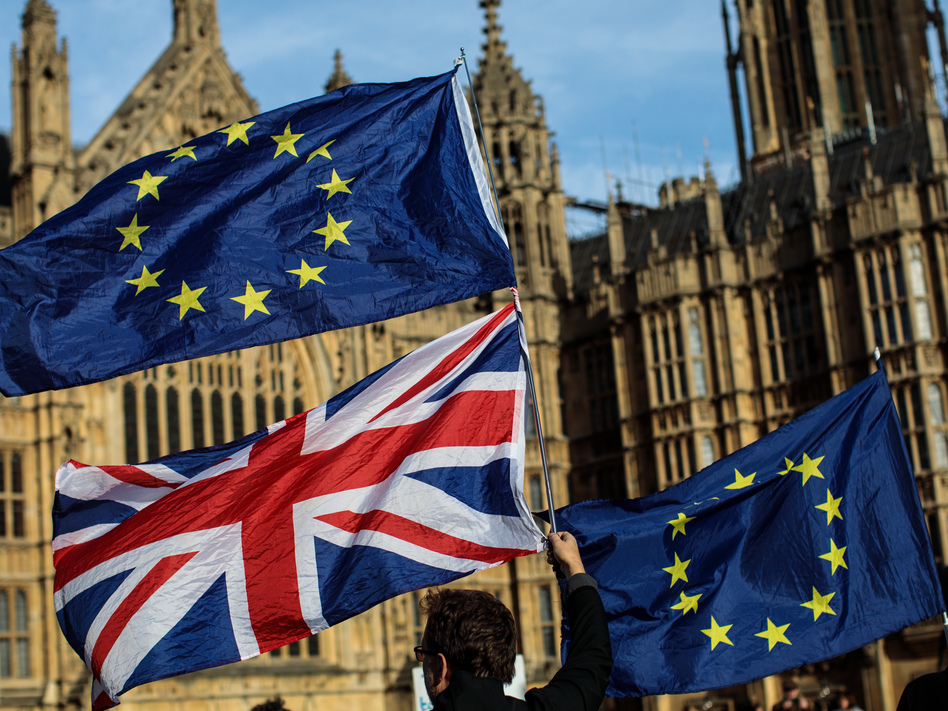 Demonstrators gather Tuesday to protest Brexit outside Parliament in London. They wave the Union Jack and the flag of the European Union. (Jack Taylor/Getty Images)