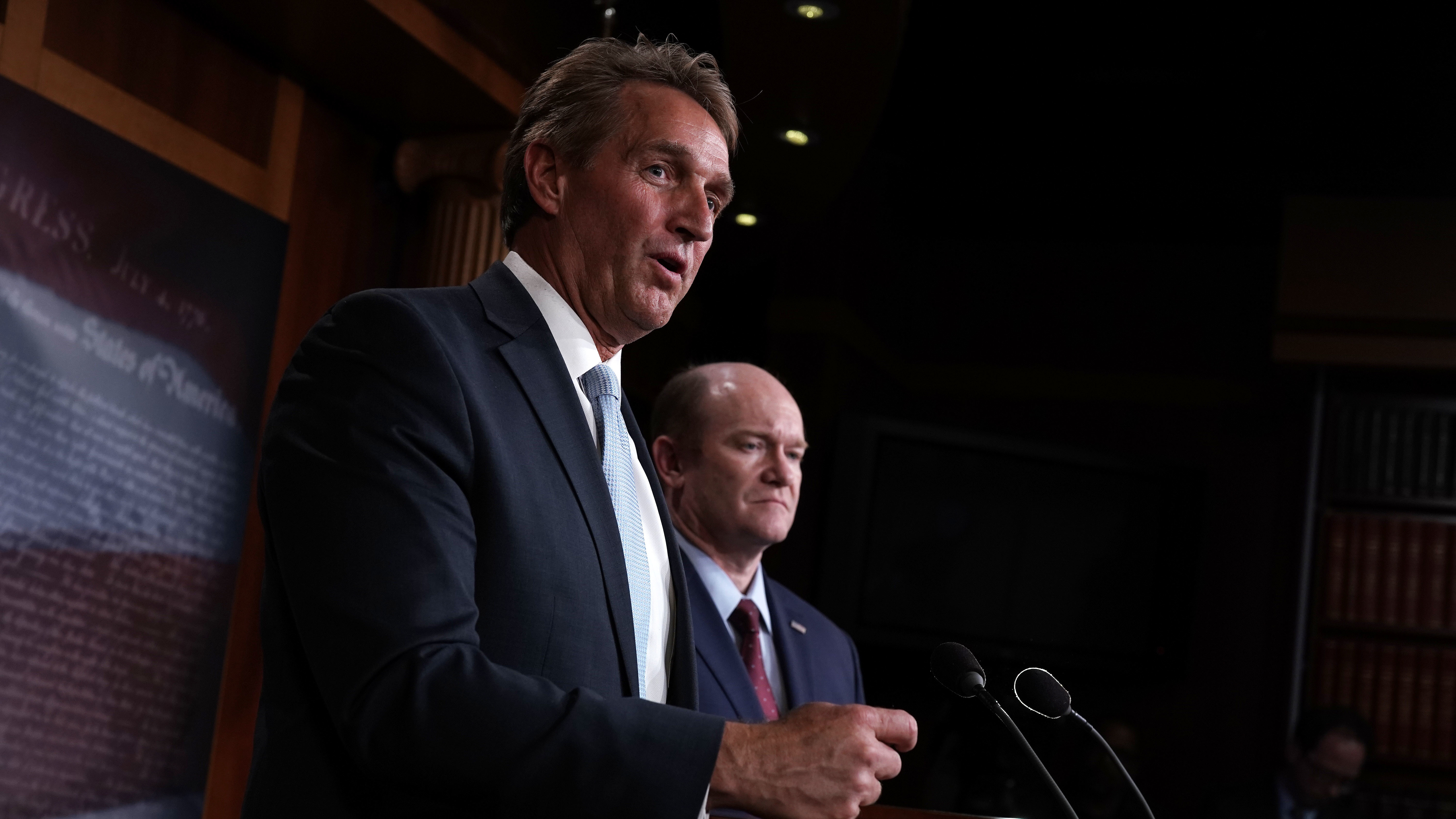 Sen. Jeff Flake, R-Ariz. (left), and Sen. Chris Coons, D-Del., speak to members of the media during a news conference Wednesday on the Special Counsel Independence and Integrity Act. (Getty Images)
