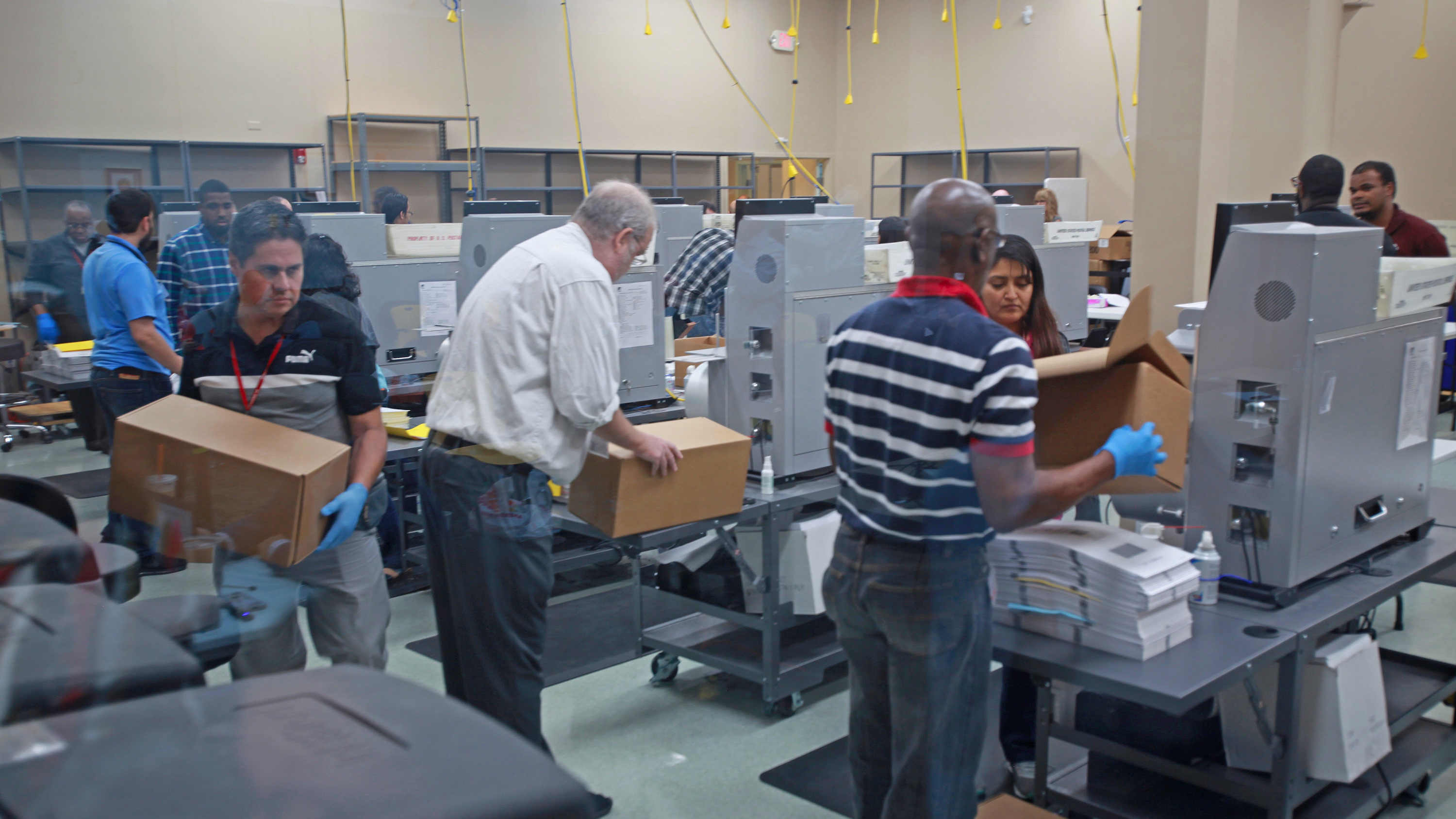 Election workers recount votes for several outstanding Florida races on Tuesday at the office of the Broward County supervisor of elections. (TNS via Getty Images)