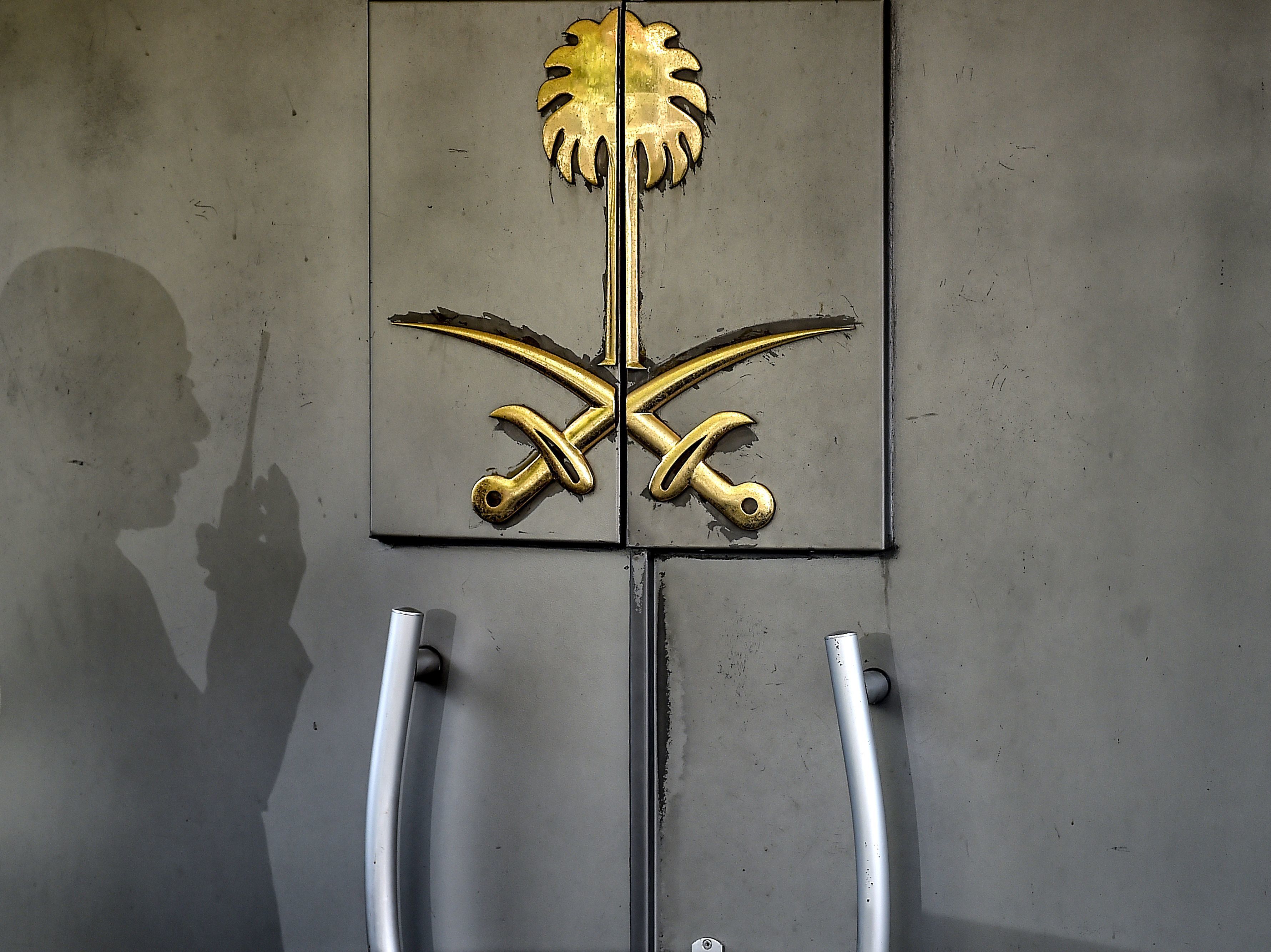 A security officer's shadow marked the door of Saudi Arabia's consulate in Istanbul. The top Saudi prosecutor now says journalist and U.S. resident Jamal Khashoggi was murdered at the diplomatic facility. (AFP/Getty Images)