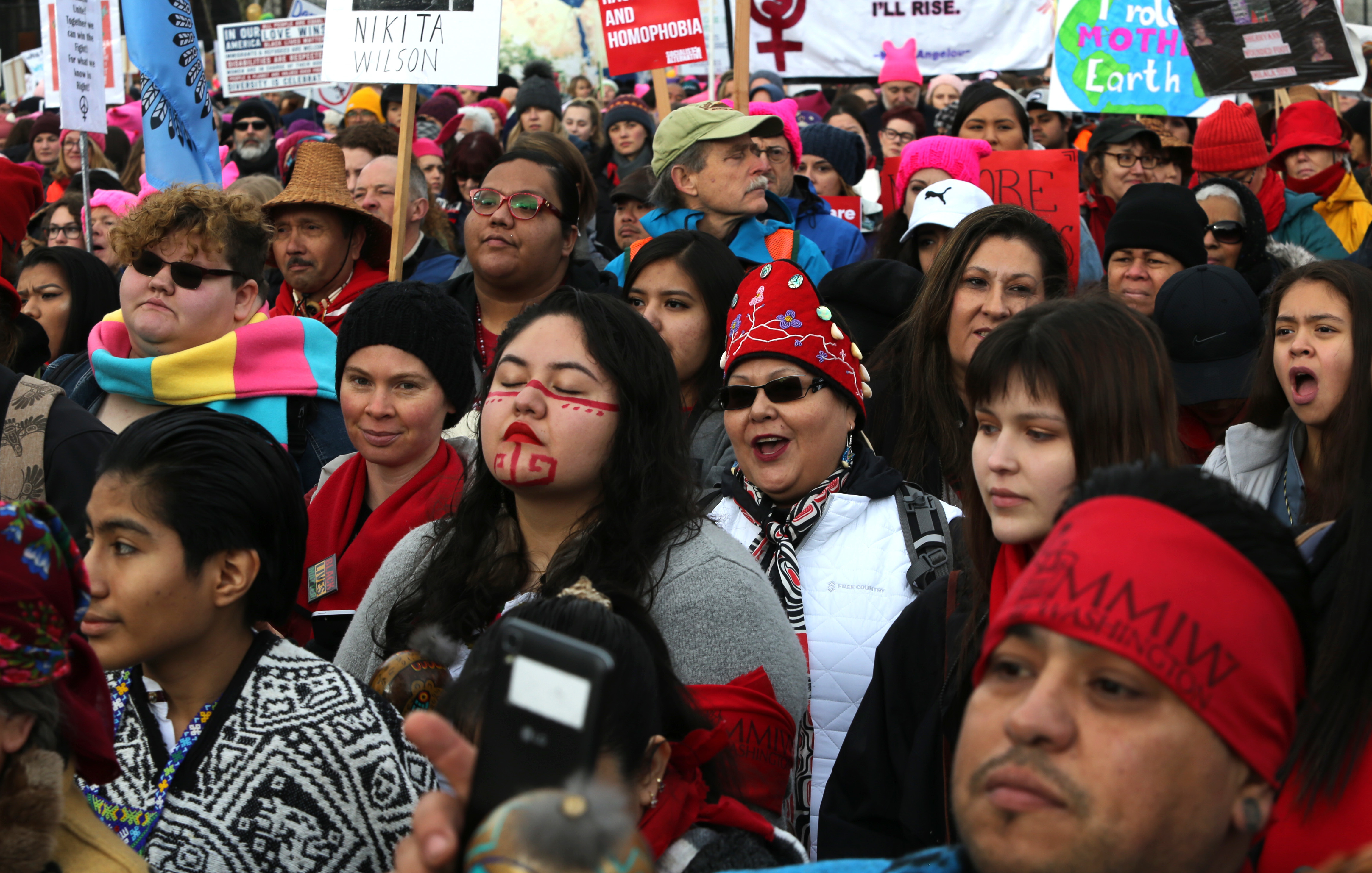 People listen to speakers raising awareness about missing and murdered Indigenous women at a rally at Cal Anderson Park in Seattle prior to the Women's March on January 20. A new report examines missing and murdered Indigenous women in cities, not on reservations, and found local law enforcement agencies often do not adequately track such crimes. (Getty Images)