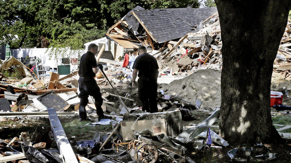 Fire investigators search the debris at a home where an explosion occurred following a gas line failure in September in Lawrence, Mass.