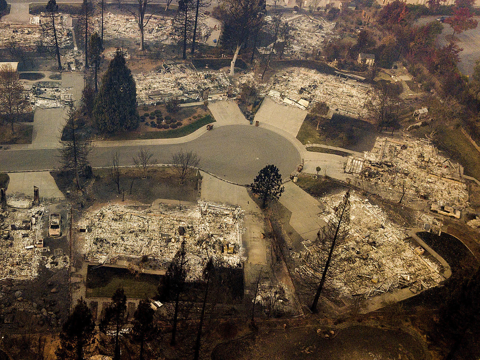 Residences leveled by the Camp Fire line a cul-de-sac in Paradise, Calif., earlier this month. A massive federal report says climate change is contributing to larger wildfires as well as other deadly extreme weather. (Noah Berger/AP)