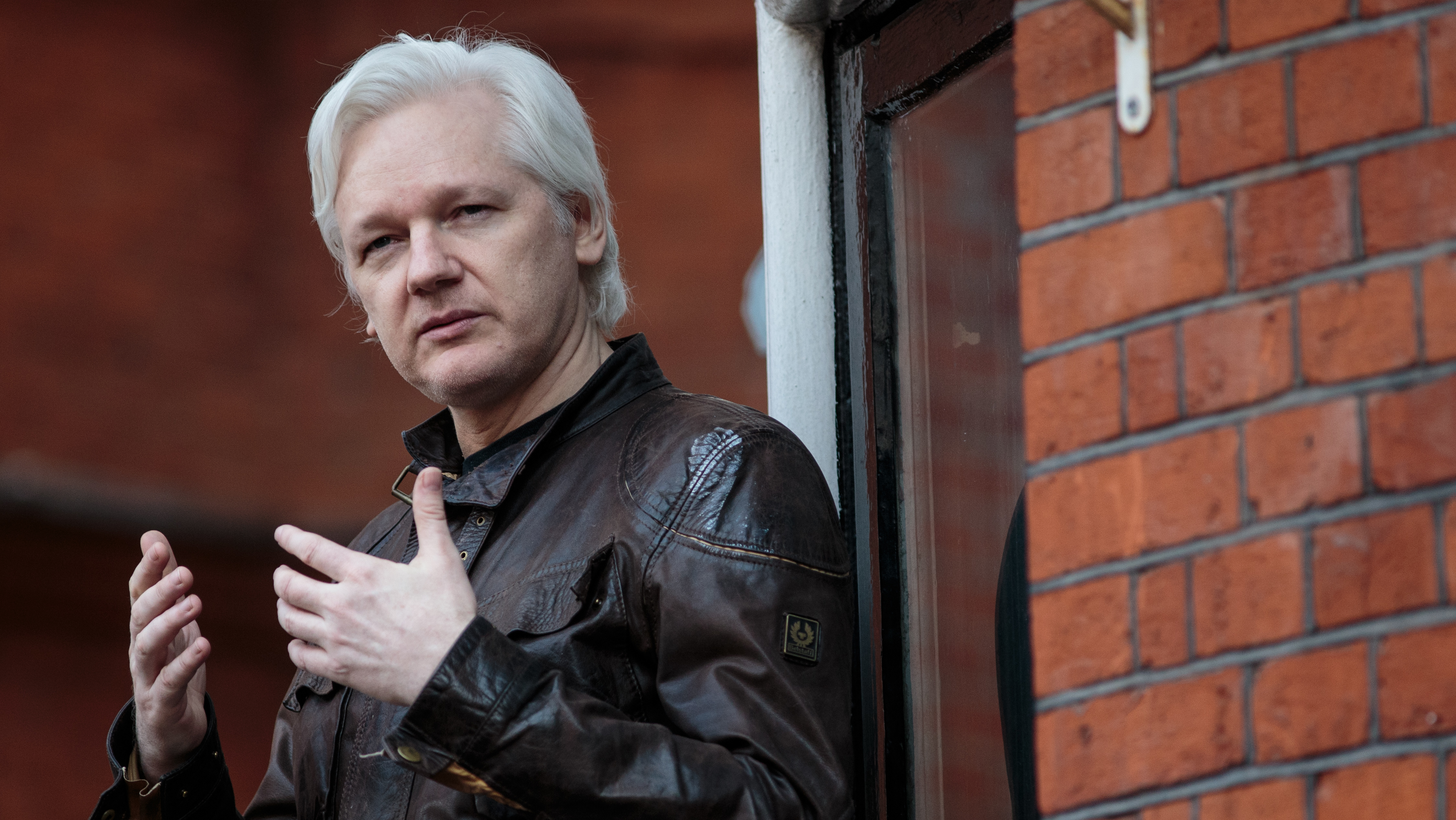 Julian Assange speaks to the media from the balcony of the Ecuadorian Embassy in London last year. (Getty Images)