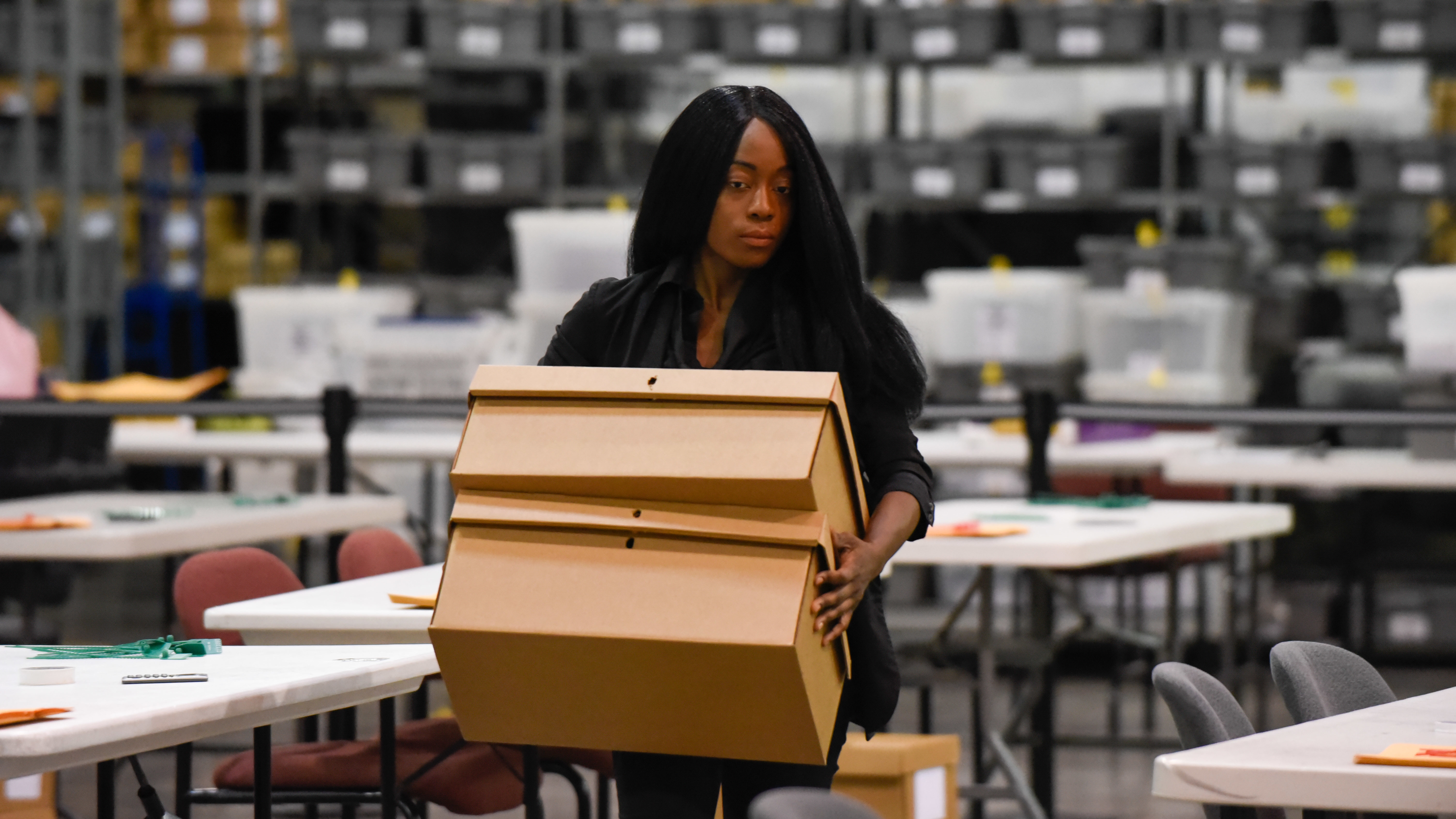 A woman sets up tables for hand-counting ballots in Palm Beach County on Thursday. (AFP/Getty Images)