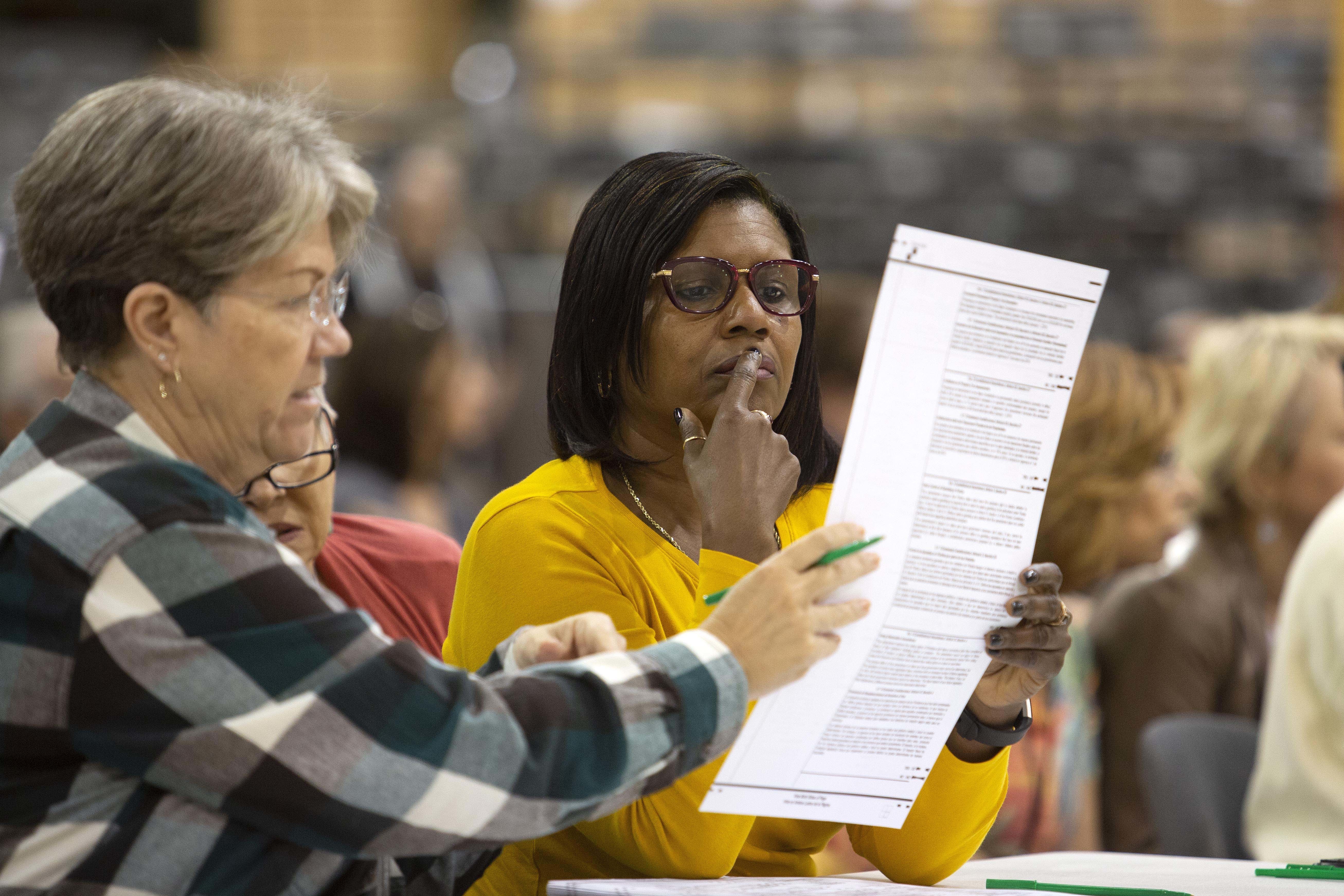 Volunteers look at ballots during a hand recount in Palm Beach, Florida. The recount decided the election in favor of the Republican candidates for Senate and governor but election experts warn that similar problems could crop up again in 2020 if the state doesn't address them immediately. (Getty Images)