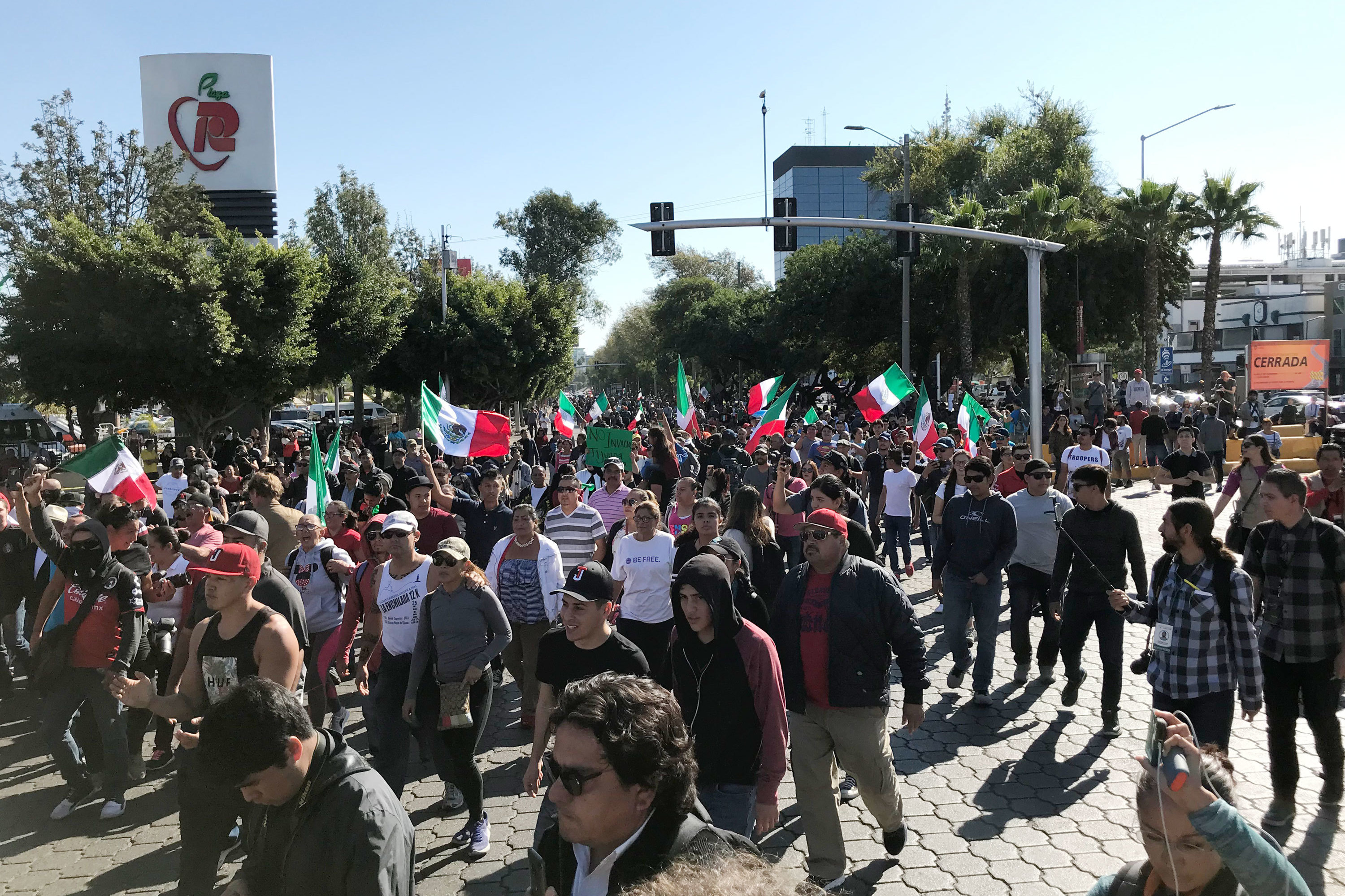 A few hundred people gathered in Tijuana's high-end Rio area on Sunday to protest against groups migrating from Central American countries. (James Fredrick for NPR)