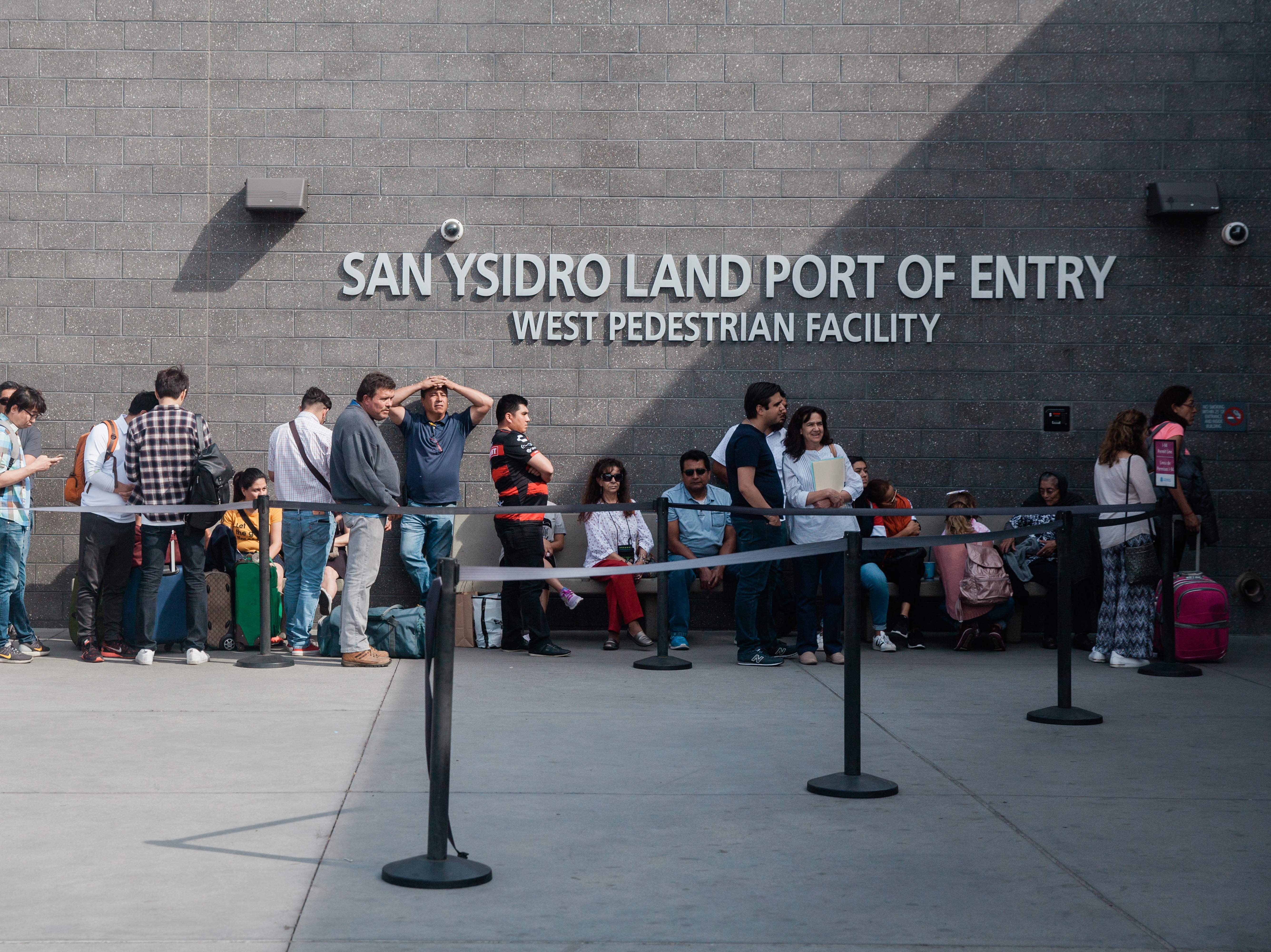 People wait in line outside the San Ysidro Port of Entry, between Tijuana, Mexico, and San Diego, Calif., in October. (AFP/Getty Images)