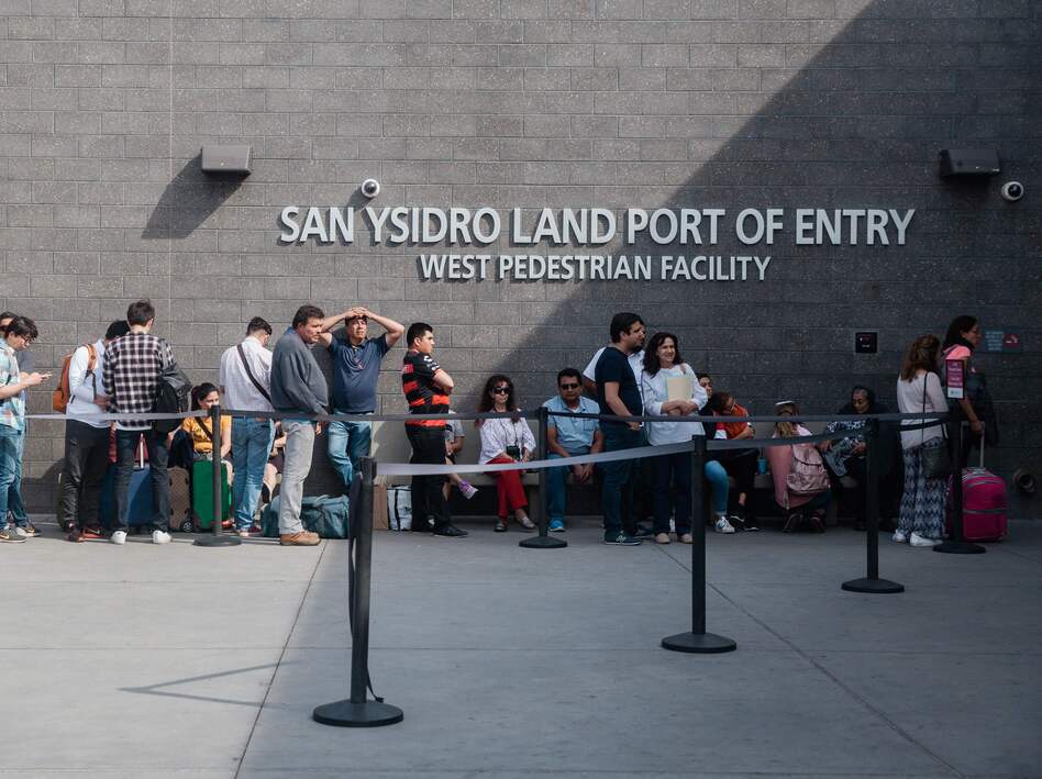 People wait in line outside the San Ysidro Port of Entry, between Tijuana, Mexico, and San Diego, Calif., in October. (Ariana Drehsler/AFP/Getty Images)