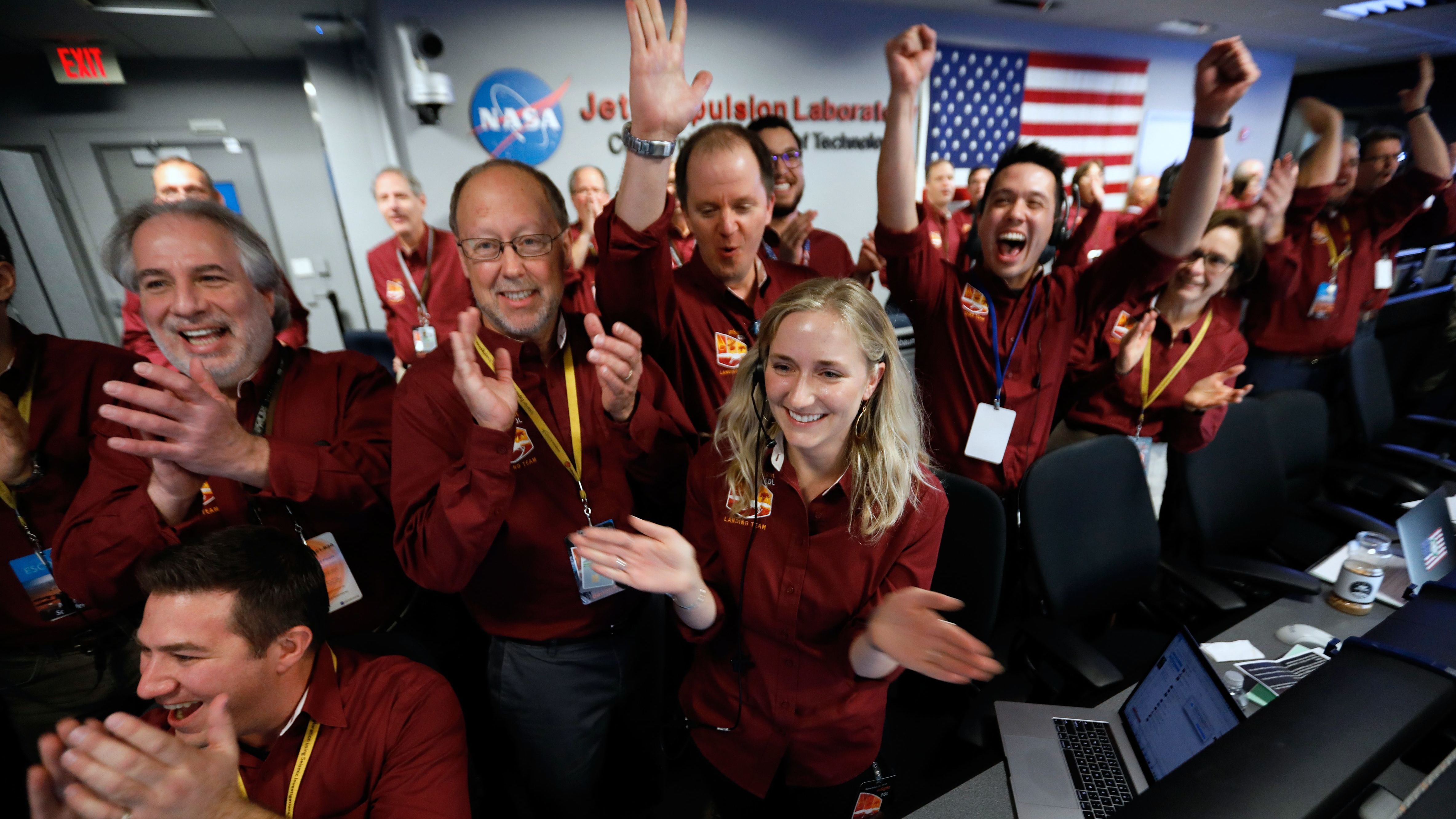 NASA engineers on the flight team celebrate the InSight spacecraft